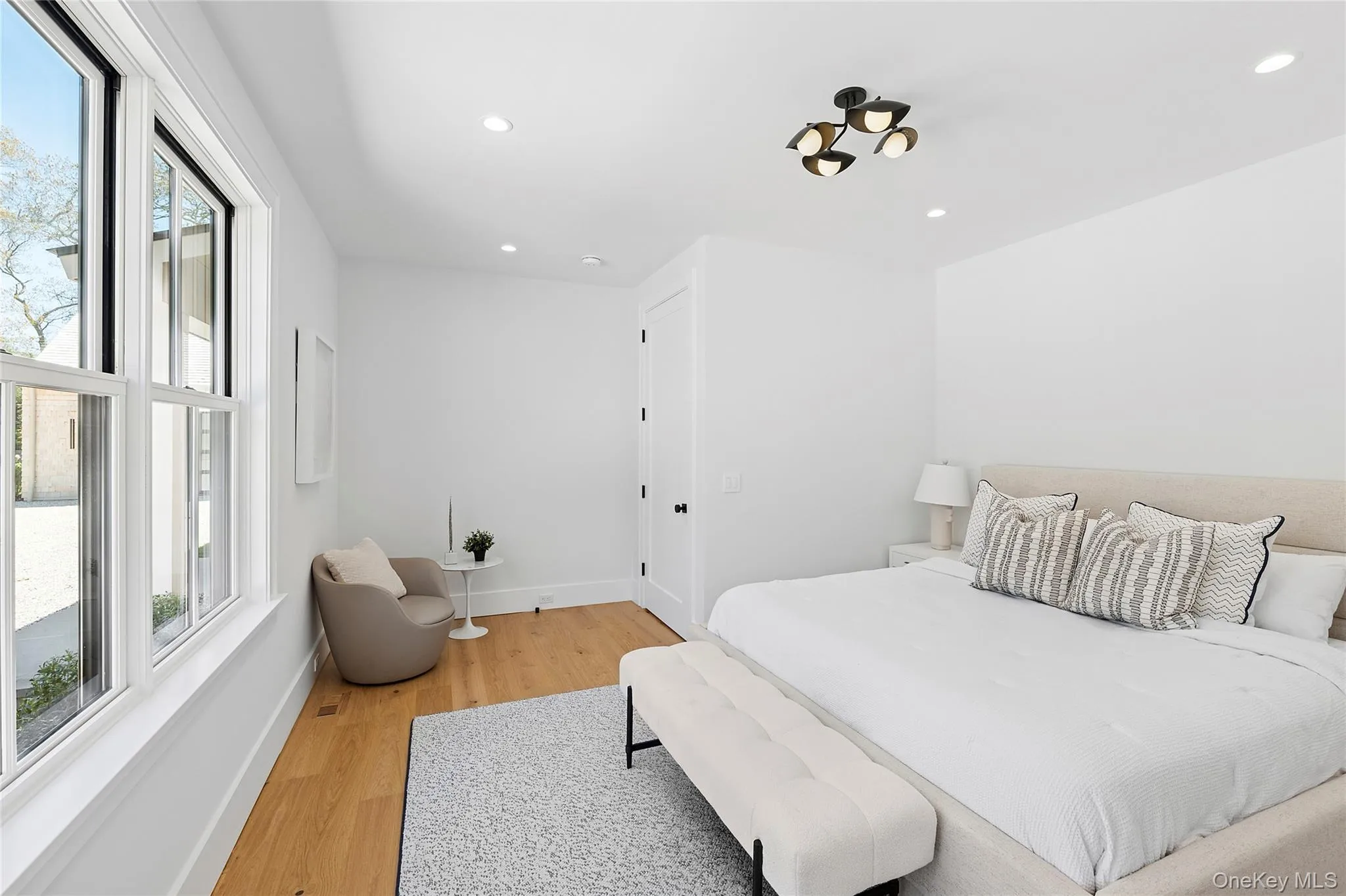 Bedroom with light wood-style flooring and recessed lighting Bedroom with light wood-style flooring and recessed lighting