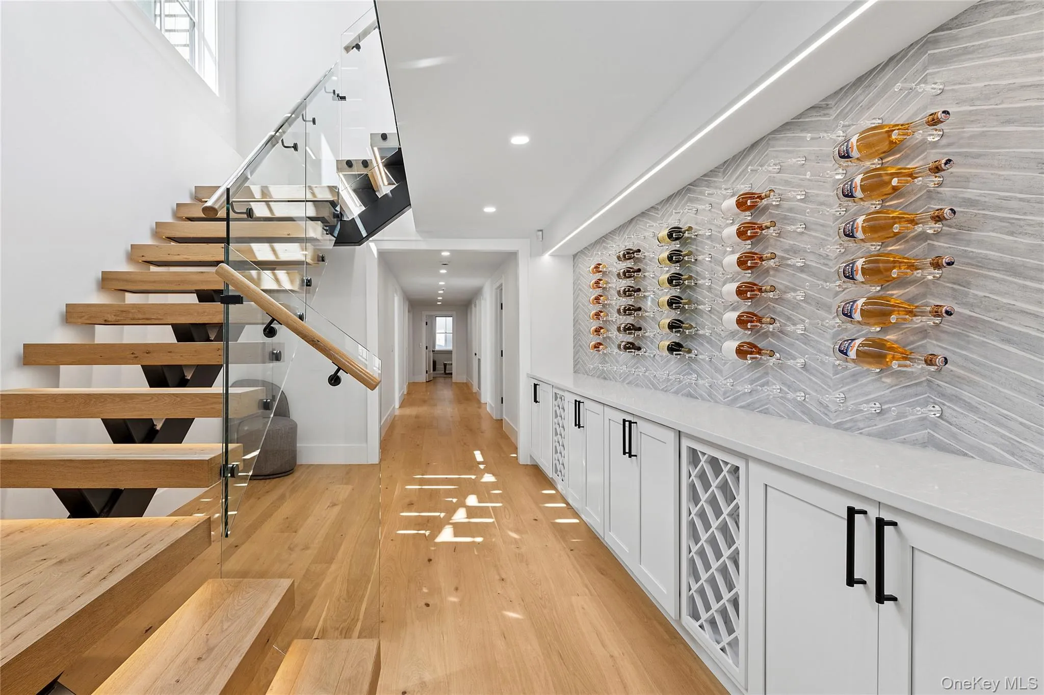 Wine area featuring light wood-type flooring and recessed lighting Wine area featuring light wood-type flooring and recessed lighting