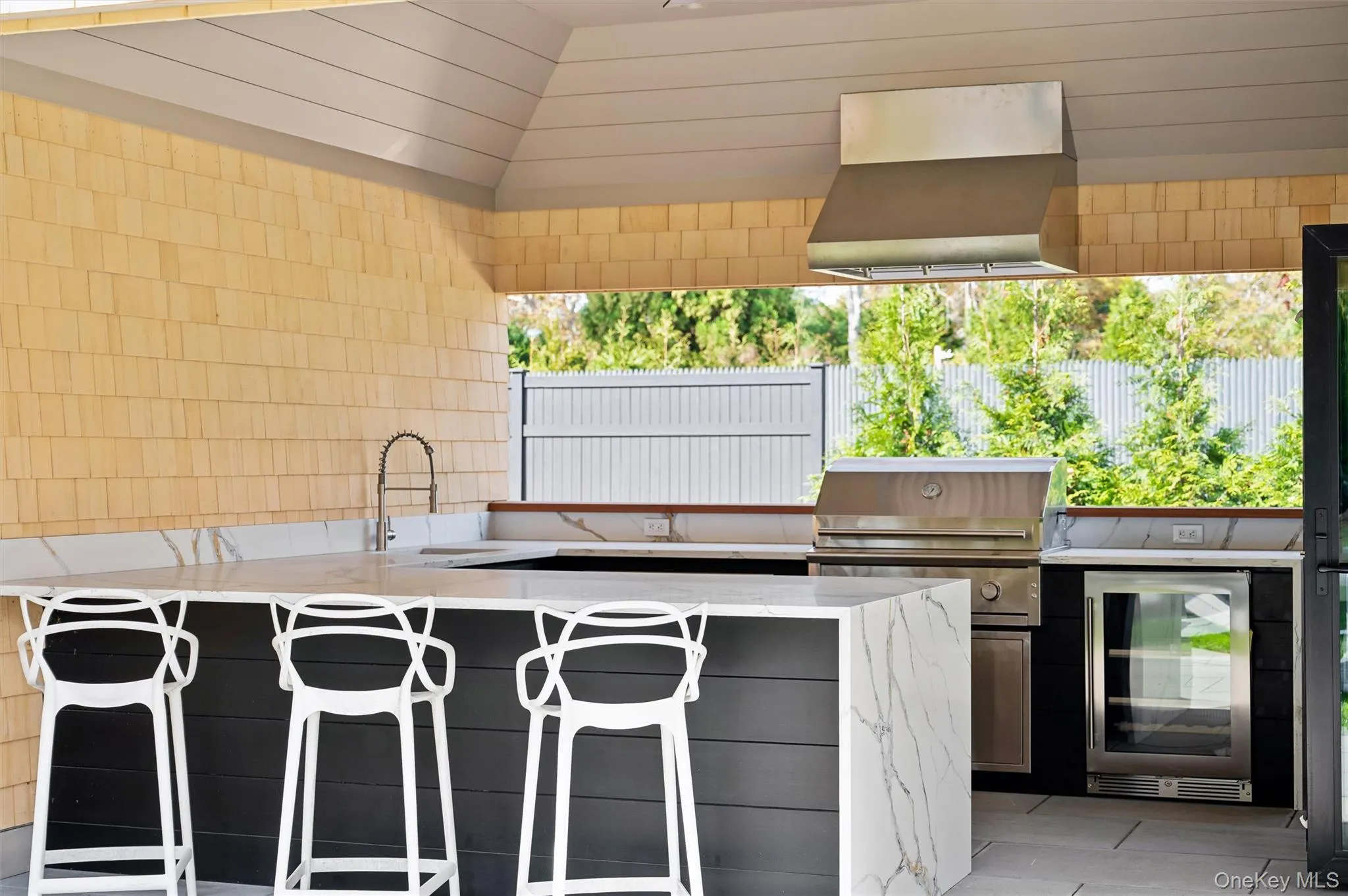 View of patio / terrace featuring wine cooler and an outdoor kitchen View of patio / terrace featuring wine cooler and an outdoor kitchen