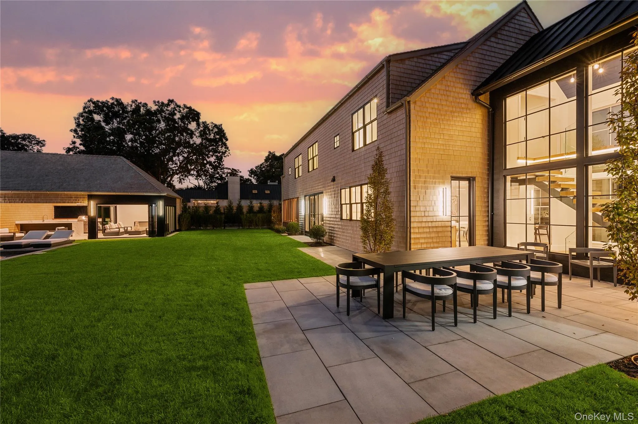 Yard at dusk featuring a patio area, outdoor dining area, an outdoor living space, and a yard Yard at dusk featuring a patio area, outdoor dining area, an outdoor living space, and a yard
