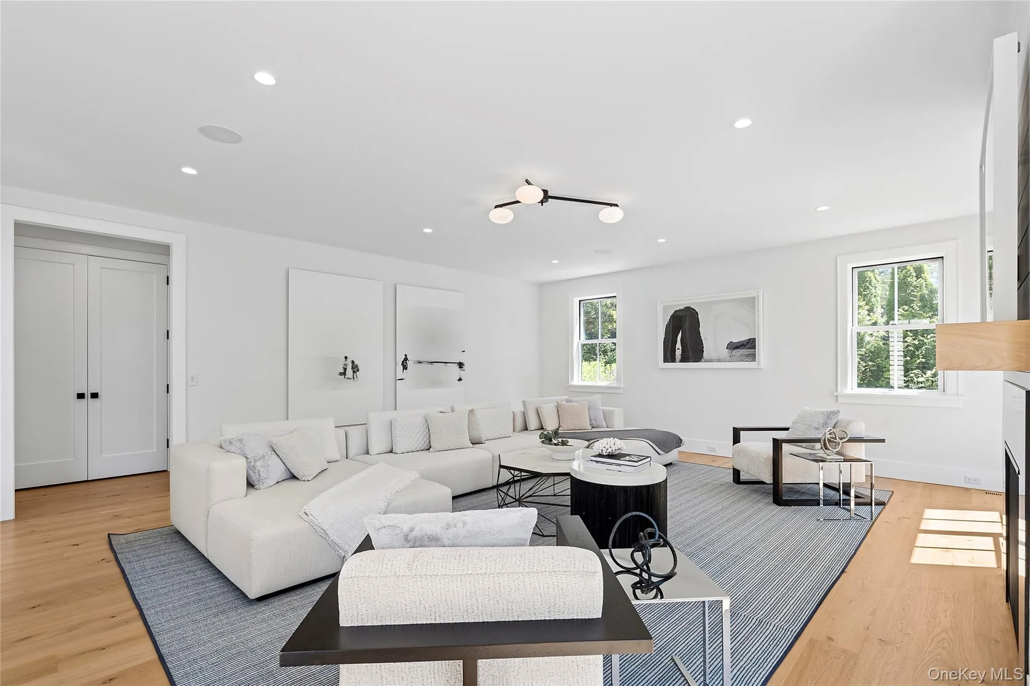 Living area featuring light wood-style floors, recessed lighting, and a fireplace Living area featuring light wood-style floors, recessed lighting, and a fireplace