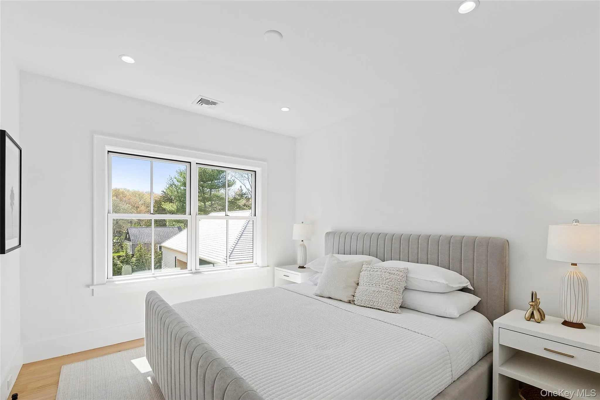 Bedroom featuring wood finished floors and recessed lighting Bedroom featuring wood finished floors and recessed lighting