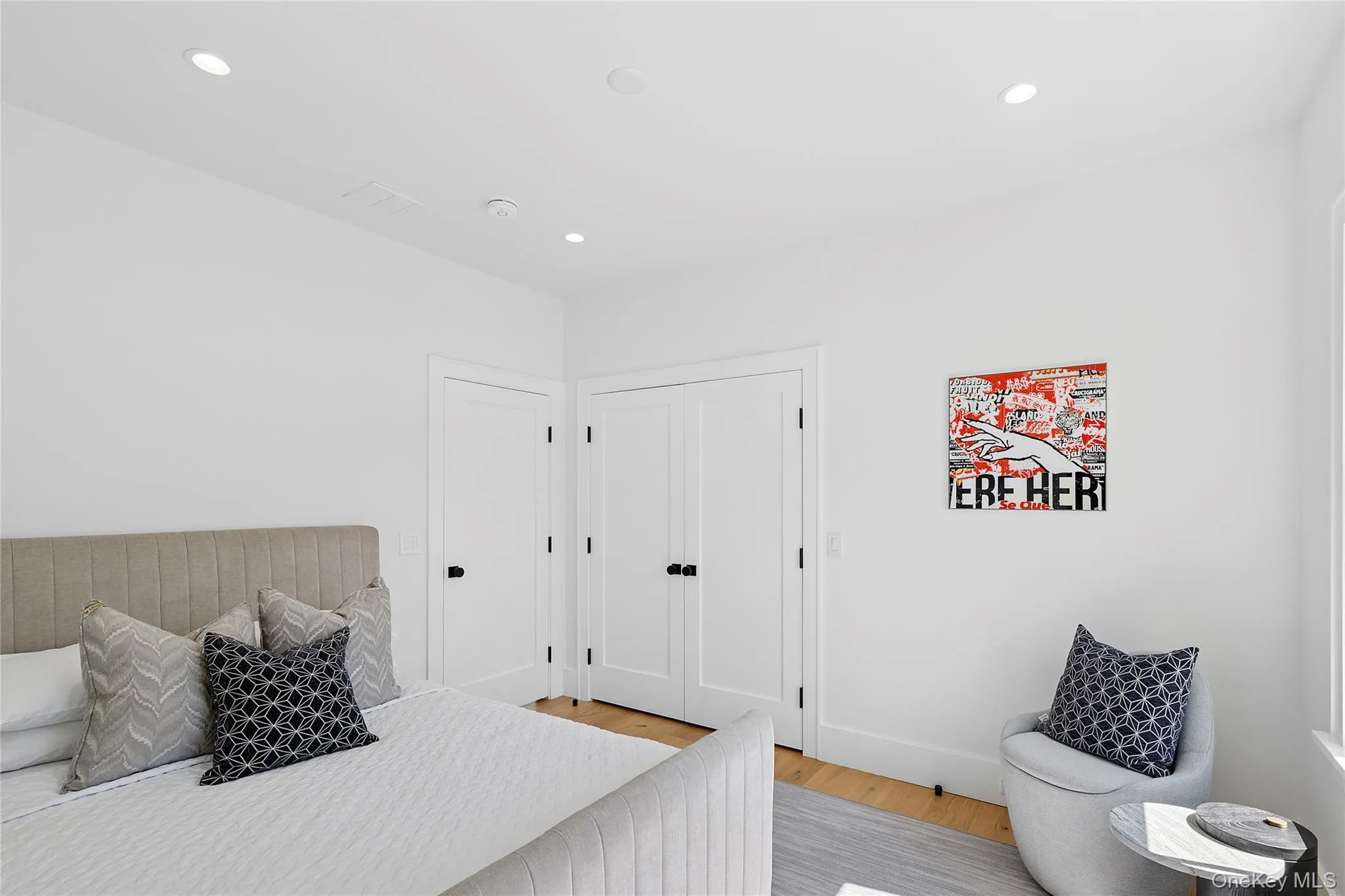 Bedroom with light wood-type flooring and recessed lighting Bedroom with light wood-type flooring and recessed lighting