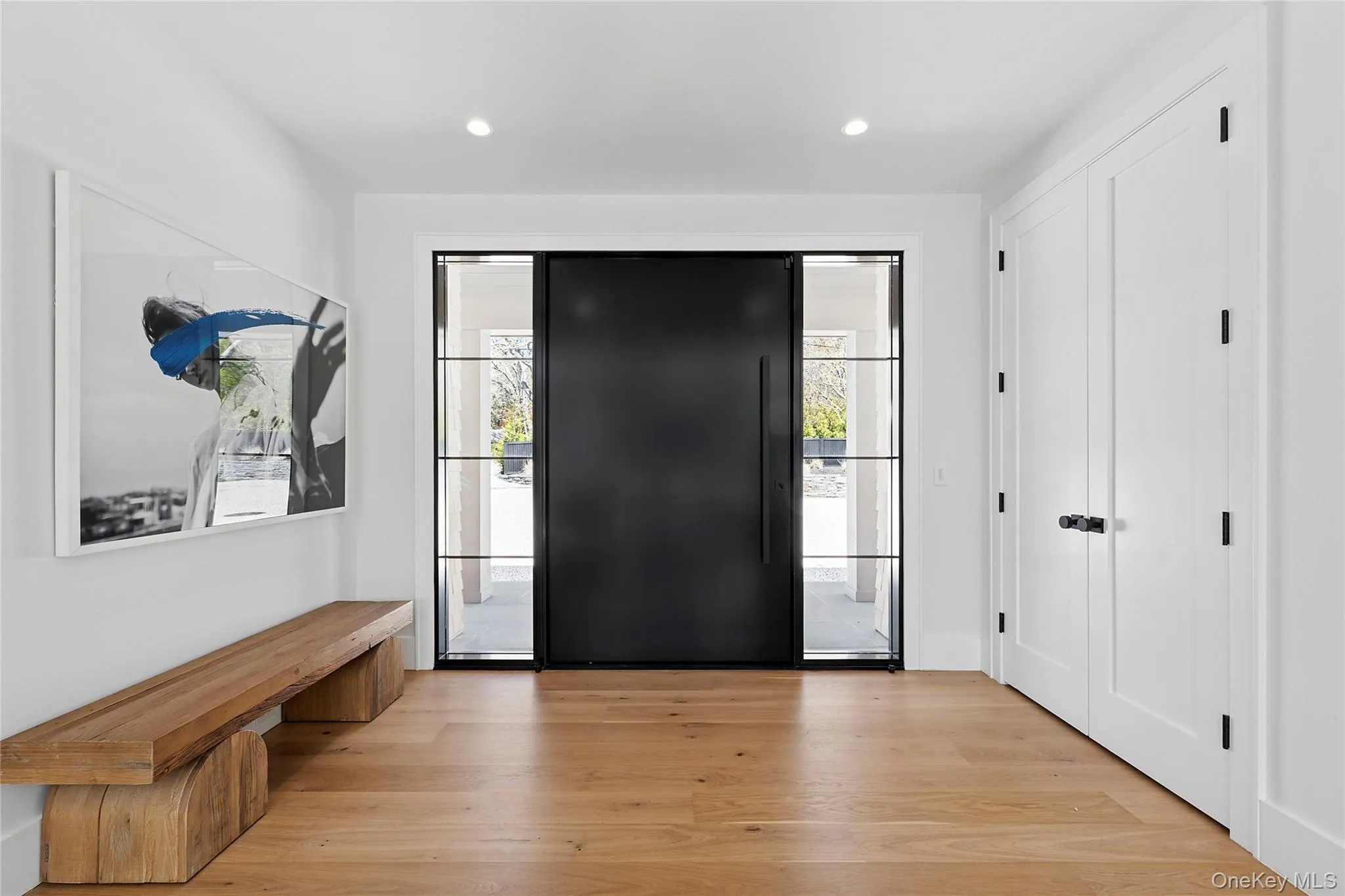 Foyer with light wood finished floors and recessed lighting Foyer with light wood finished floors and recessed lighting