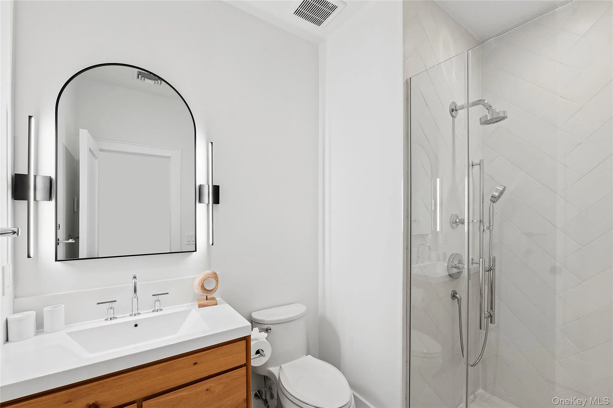 Full bathroom featuring a shower stall and vanity Full bathroom featuring a shower stall and vanity