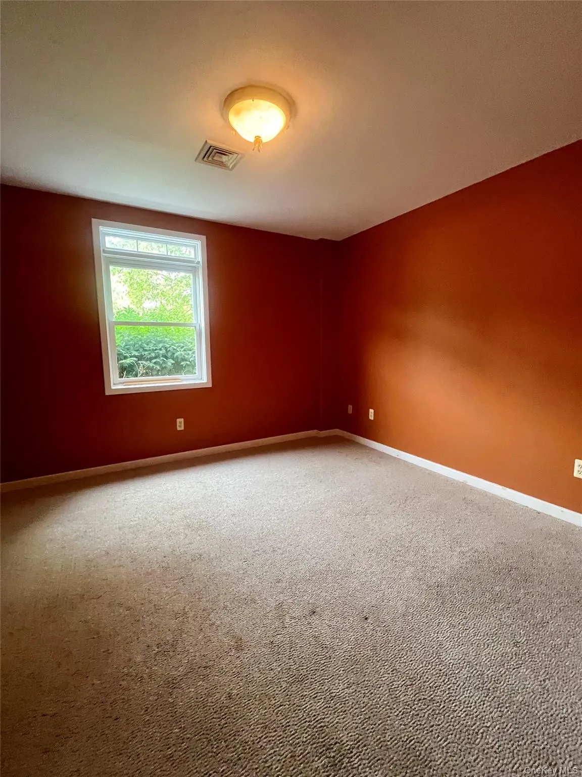 Carpeted empty room featuring baseboards Carpeted empty room featuring baseboards