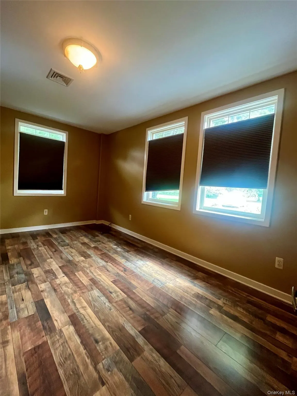 Spare room with dark wood-style floors Spare room with dark wood-style floors