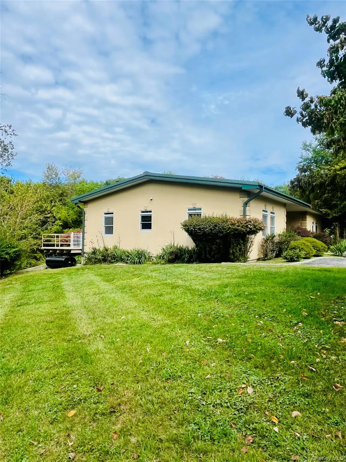 View of side of property with stucco siding and a lawn View of side of property with stucco siding and a lawn