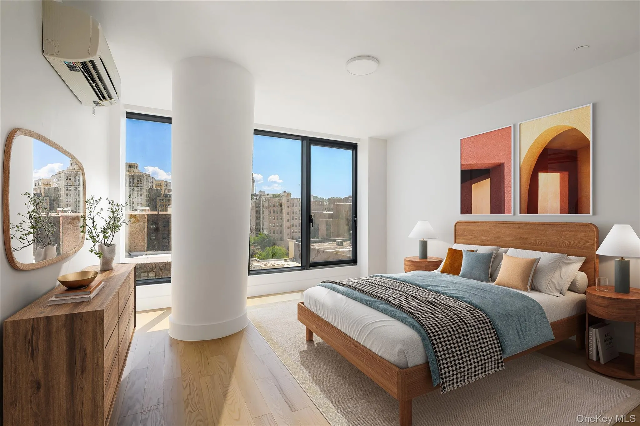 Bedroom featuring wood finished floors, a wall unit AC, and a view of city Bedroom featuring wood finished floors, a wall unit AC, and a view of city