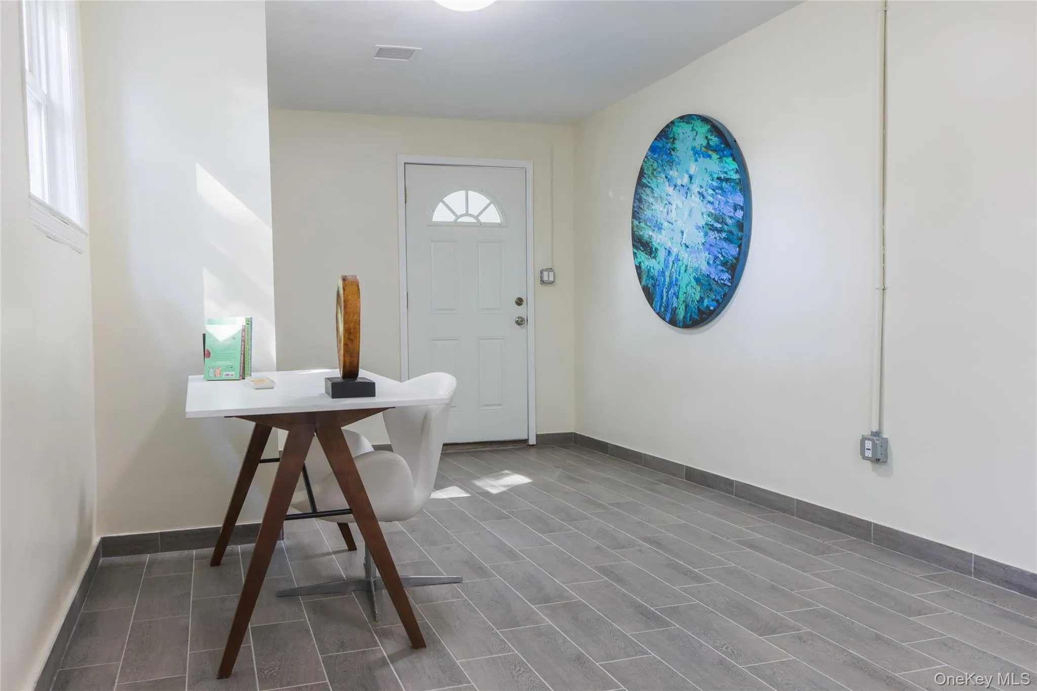 Foyer entrance with wood finish floors and baseboards Foyer entrance with wood finish floors and baseboards