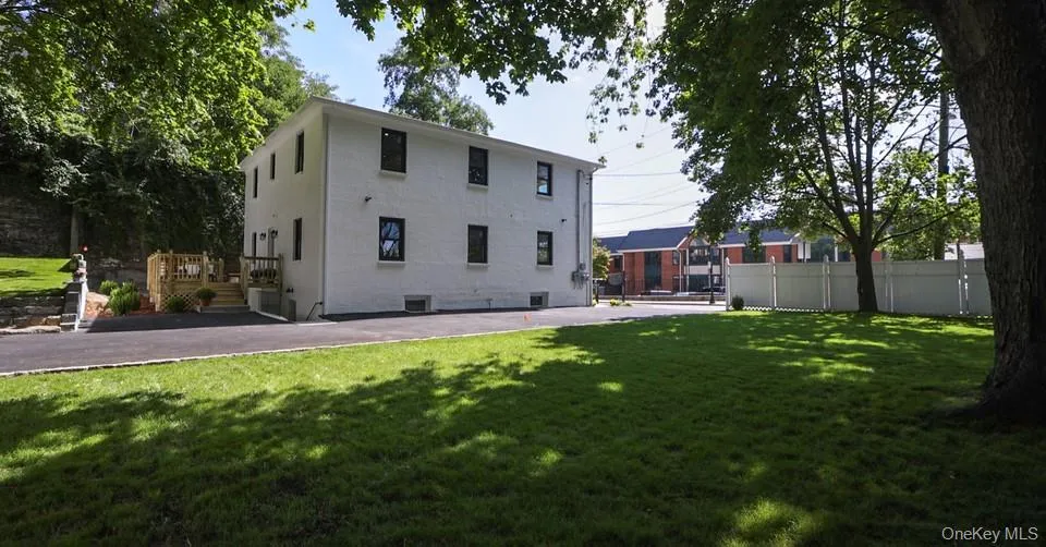 Back of property with a deck and brick siding Back of property with a deck and brick siding