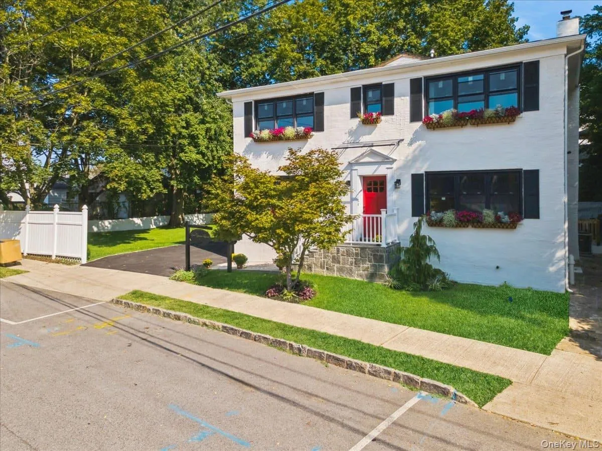 View of front of house featuring a chimney and uncovered parking View of front of house featuring a chimney and uncovered parking