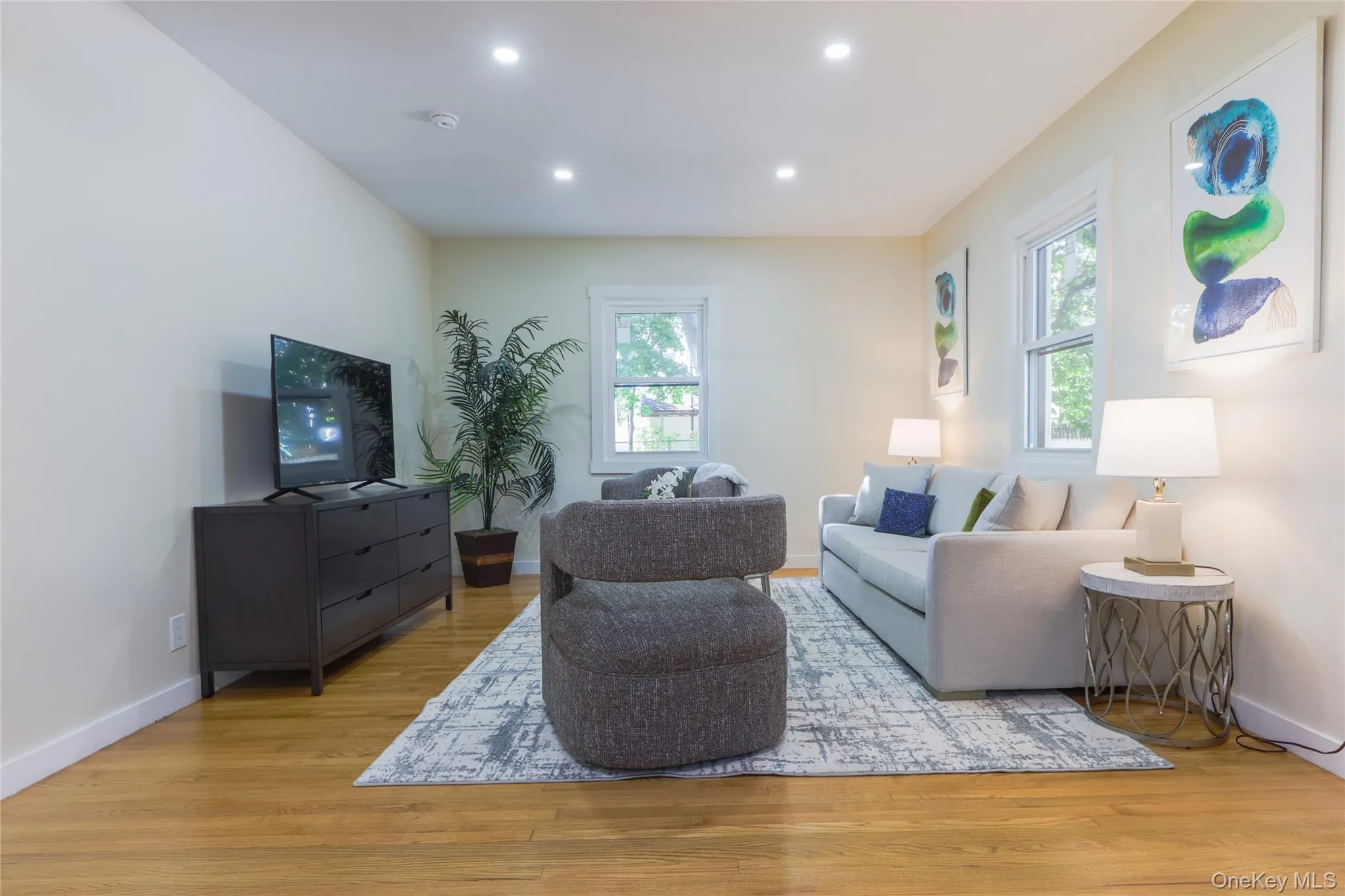 Living area with light wood finished floors and recessed lighting Living area with light wood finished floors and recessed lighting