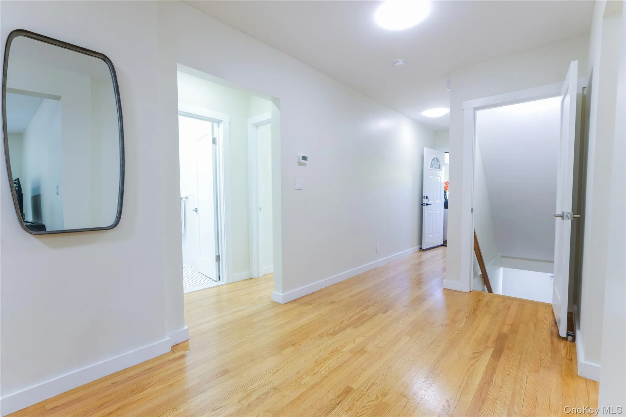 Corridor with an upstairs landing and light wood-style floors Corridor with an upstairs landing and light wood-style floors
