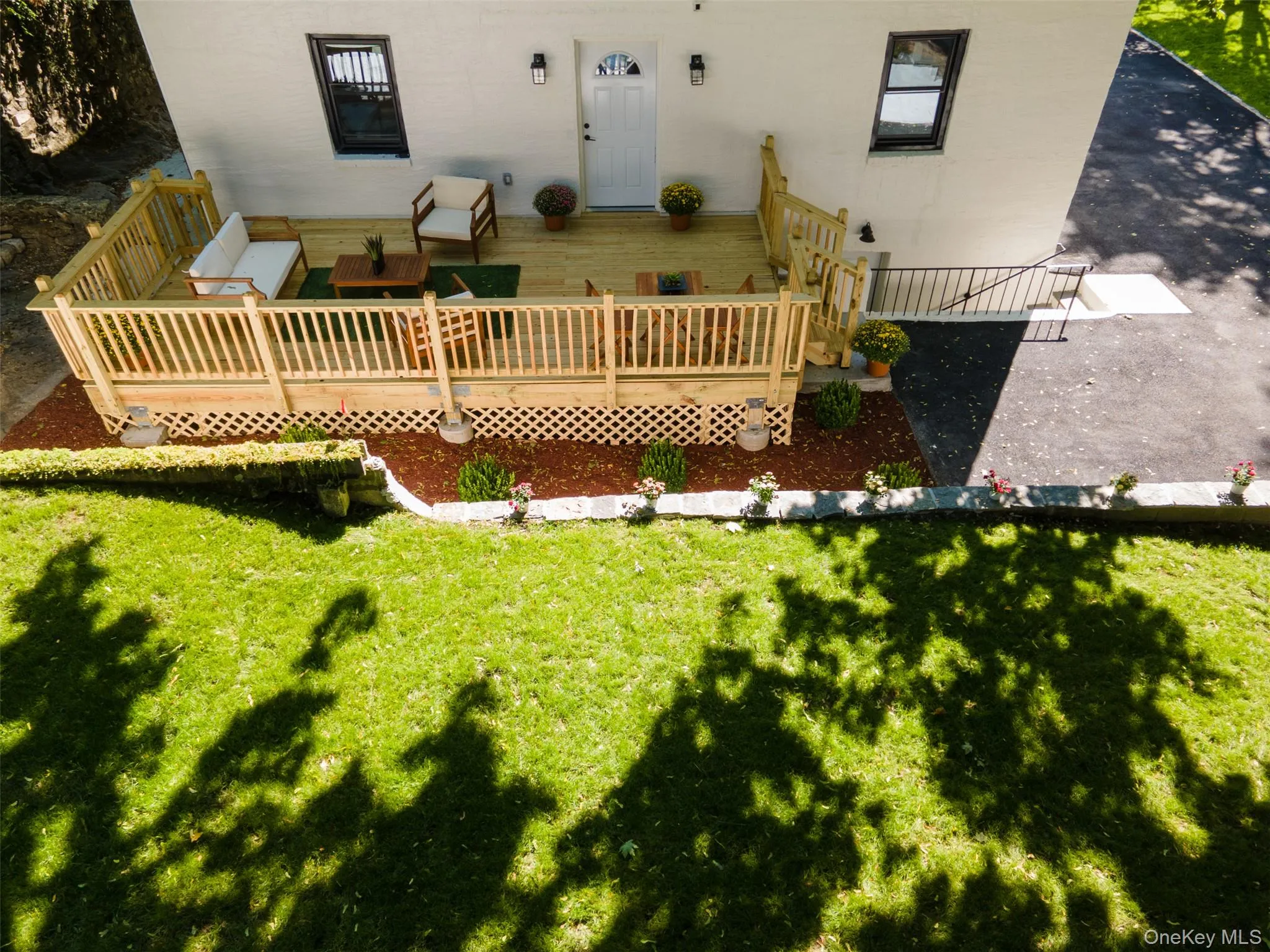 Rear view of property featuring a yard and a deck Rear view of property featuring a yard and a deck