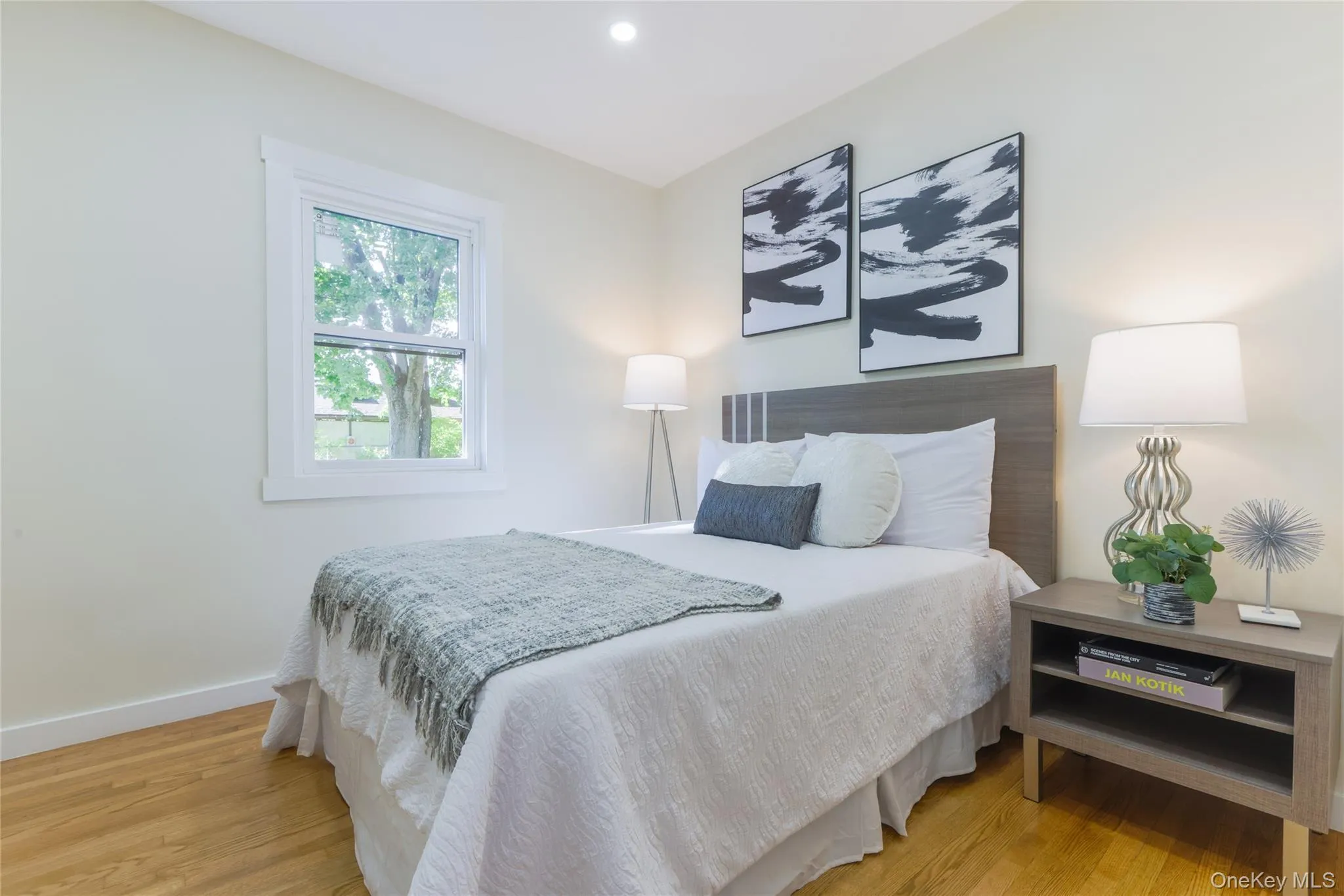Bedroom featuring light wood-type flooring and recessed lighting Bedroom featuring light wood-type flooring and recessed lighting