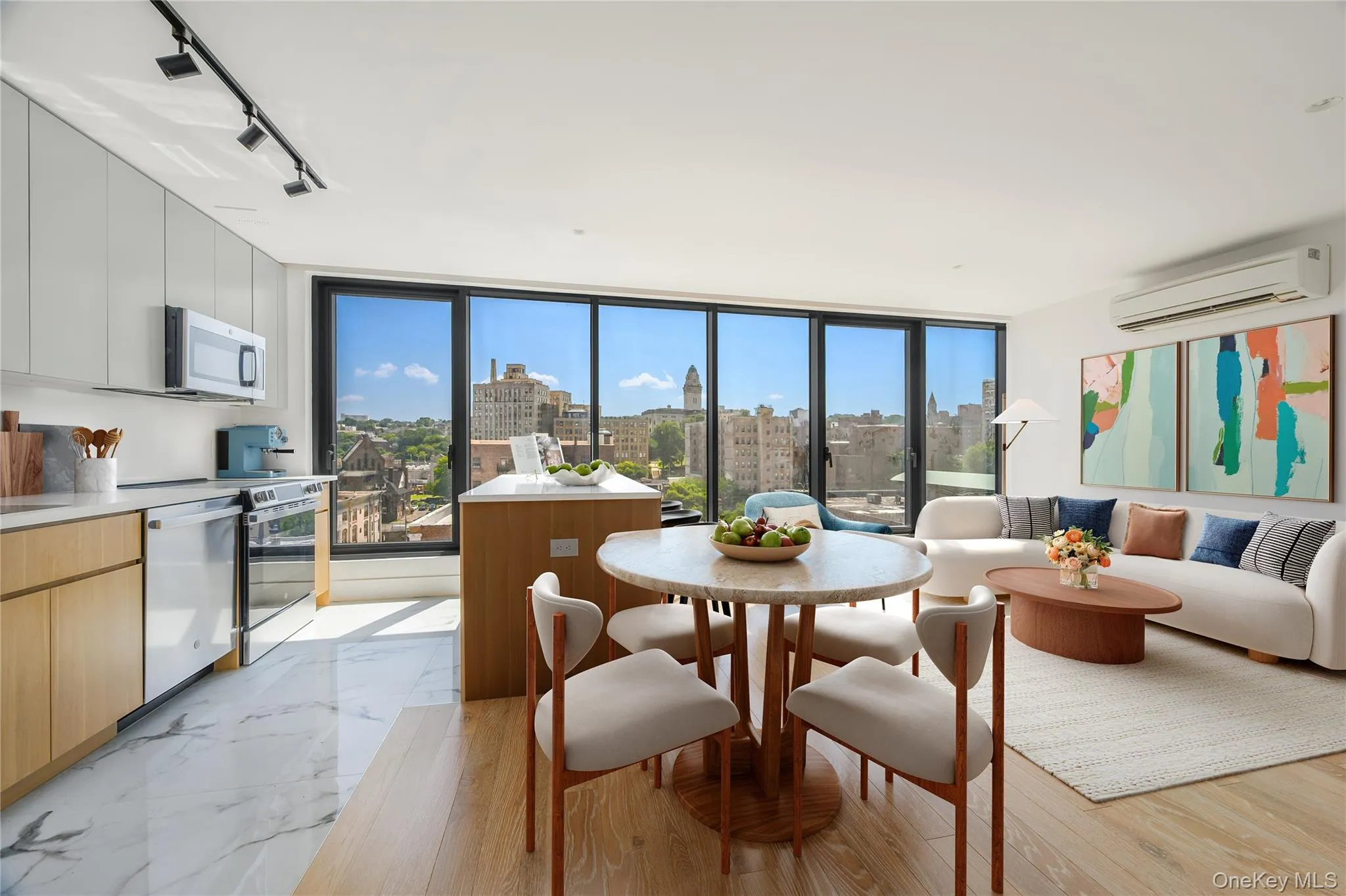 Dining area with expansive windows, plenty of natural light, rail lighting, a city view, and a wall mounted air conditioner Dining area with expansive windows, plenty of natural light, rail lighting, a city view, and a wall mounted air conditioner