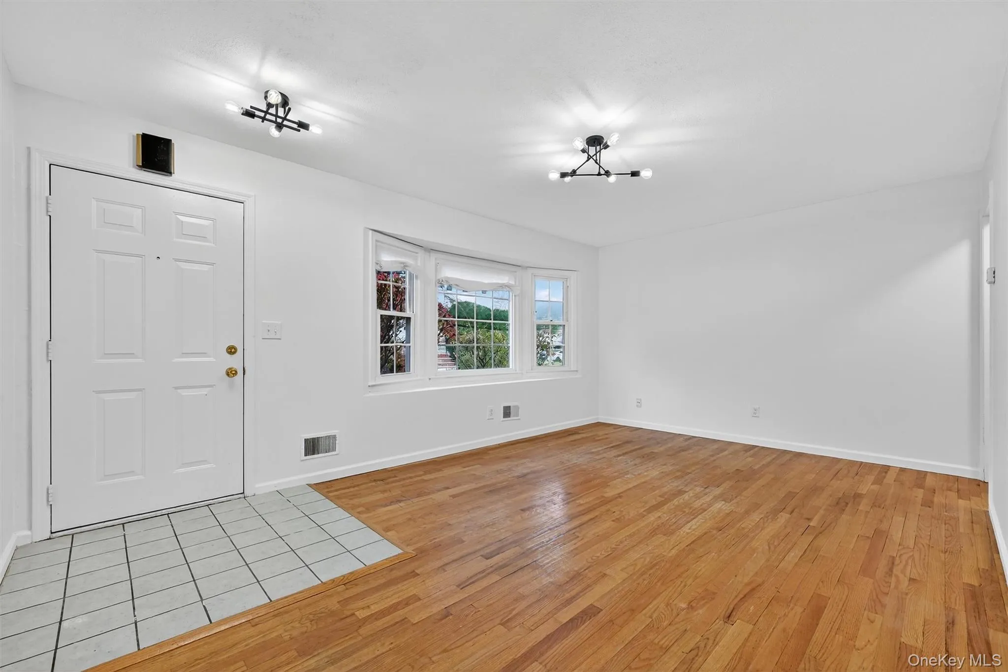 Foyer with light wood-style flooring and a chandelier Foyer with light wood-style flooring and a chandelier