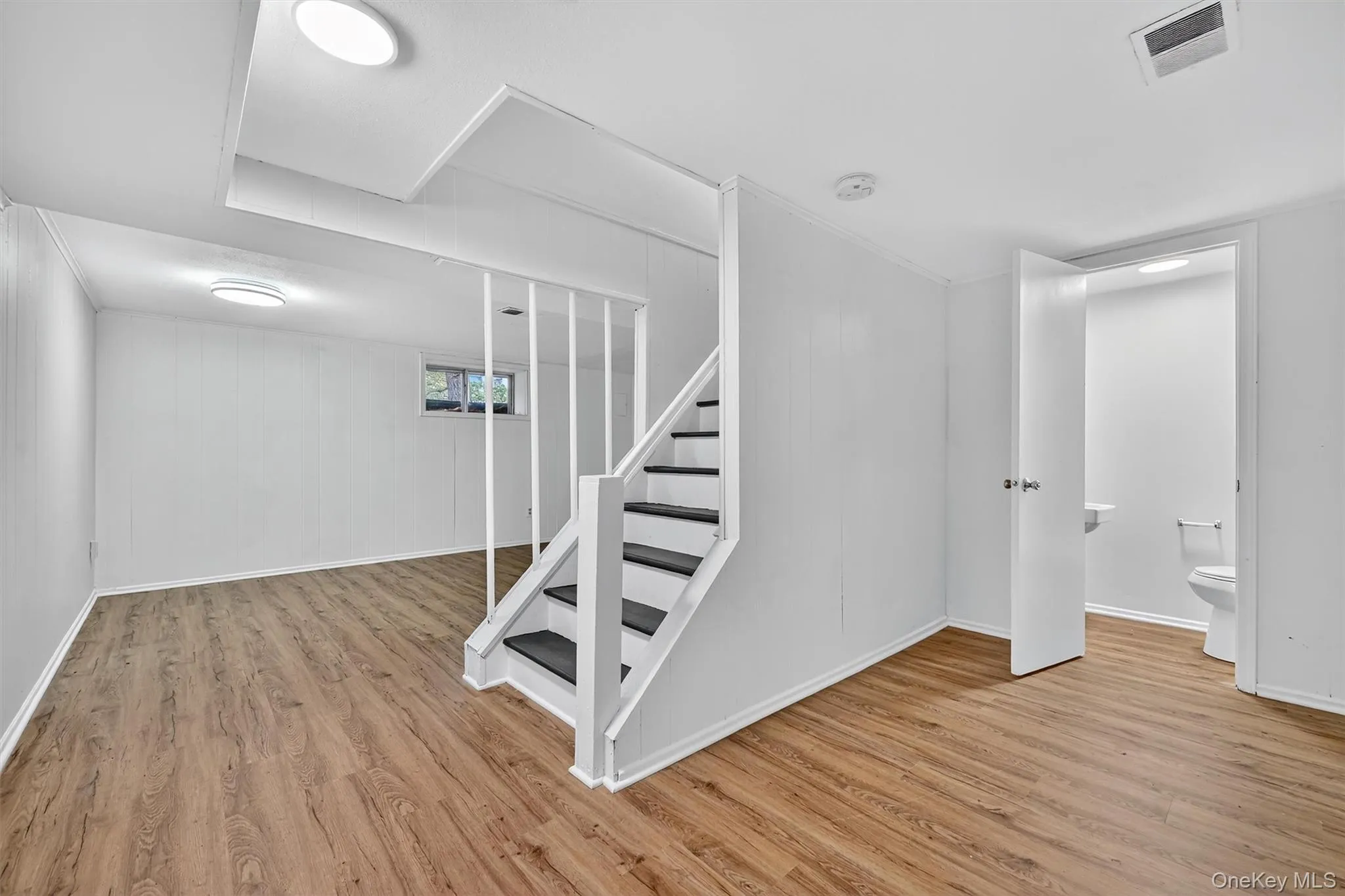 Stairway featuring wood finished floors and baseboards Stairway featuring wood finished floors and baseboards