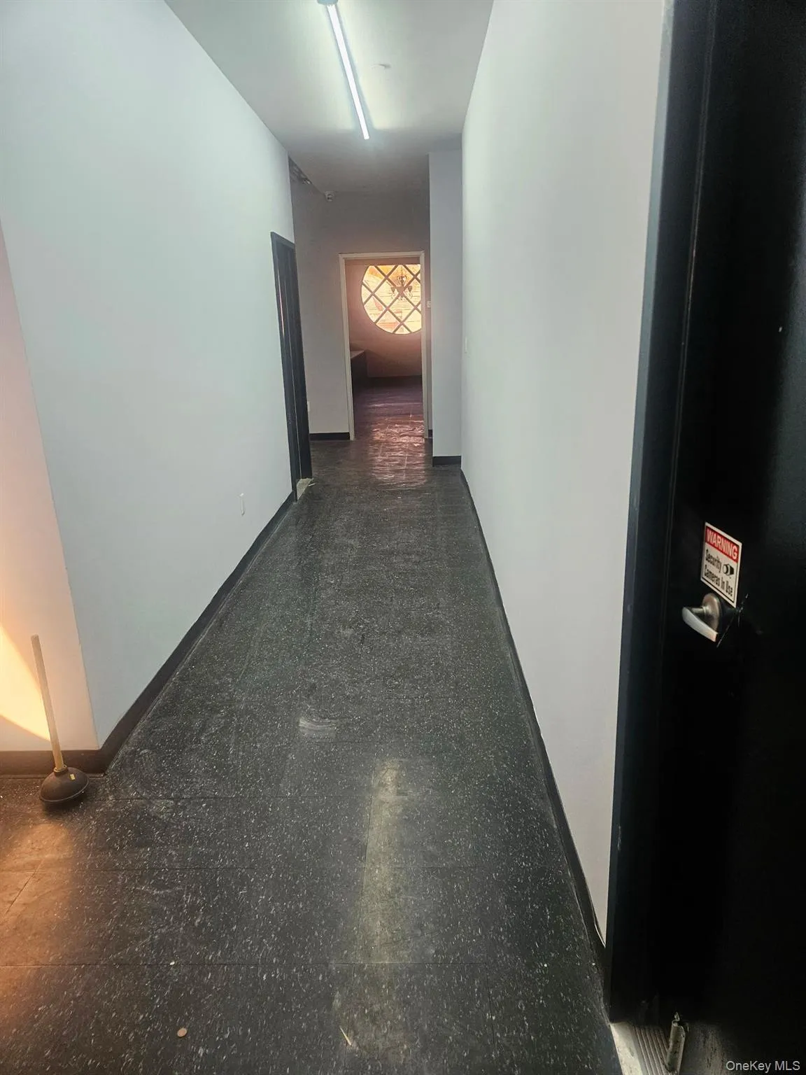 Hall with baseboards and granite tiled floors Hall with baseboards and granite tiled floors