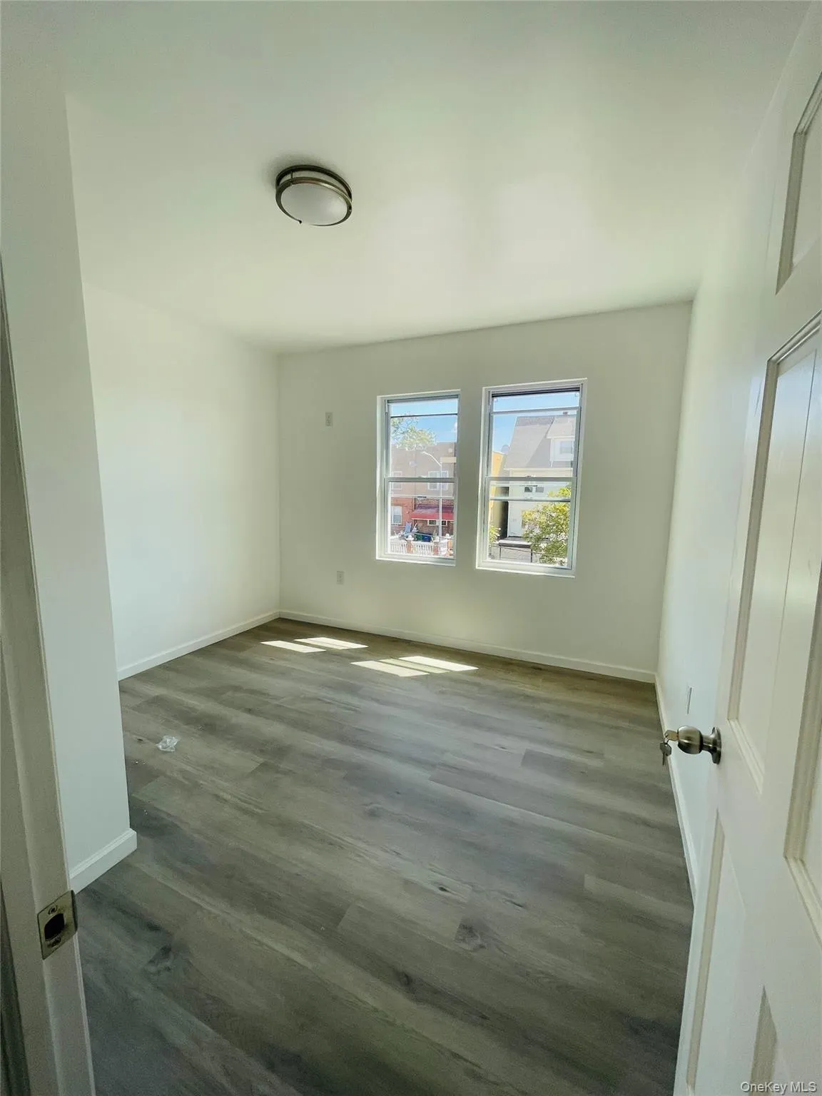 Unfurnished bedroom with wood finished floors and baseboards Unfurnished bedroom with wood finished floors and baseboards