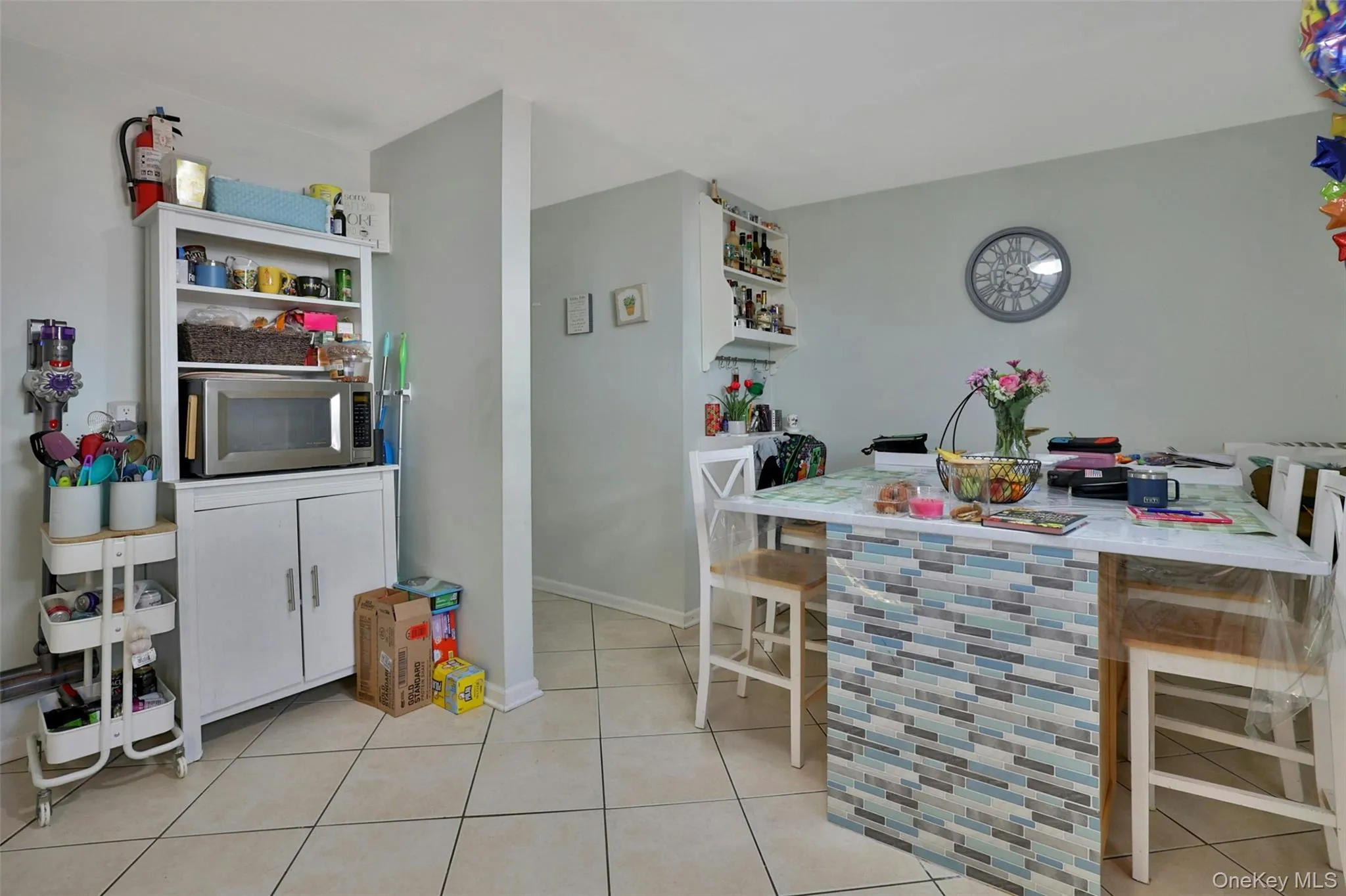 Dining space featuring light tile patterned floors and baseboards Dining space featuring light tile patterned floors and baseboards
