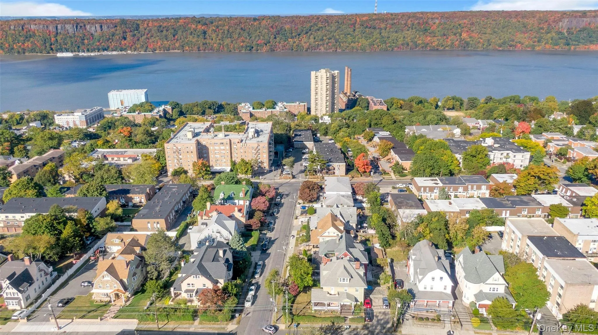 Aerial view of property and surrounding area with a nearby body of water Aerial view of property and surrounding area with a nearby body of water