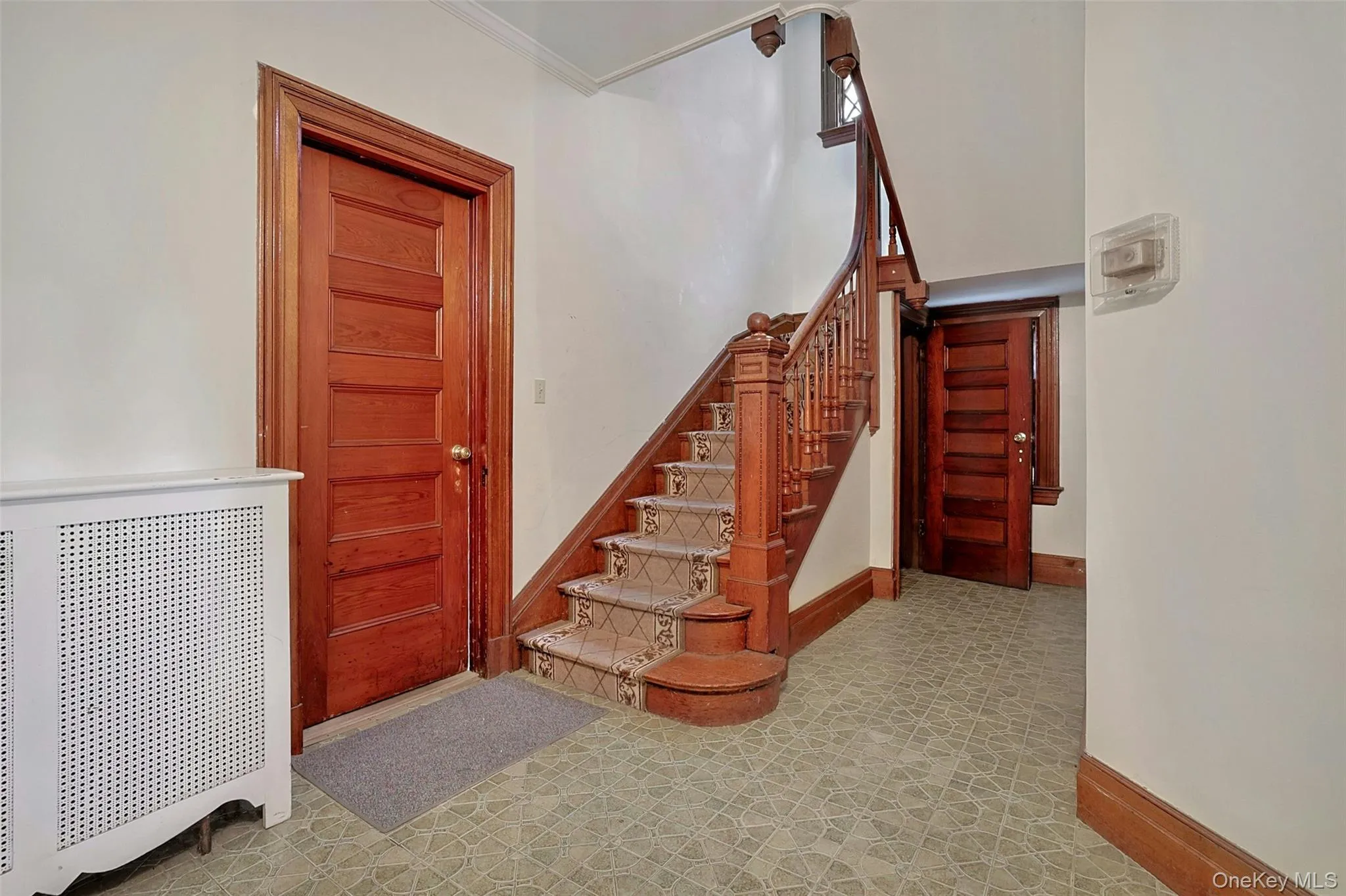 Stairway featuring radiator and crown molding Stairway featuring radiator and crown molding