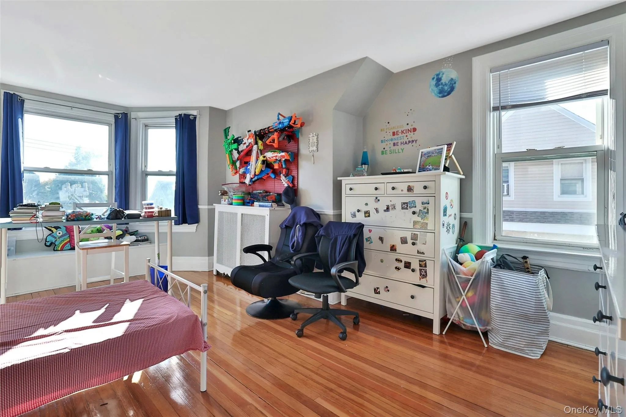 Bedroom with hardwood / wood-style flooring and baseboards Bedroom with hardwood / wood-style flooring and baseboards