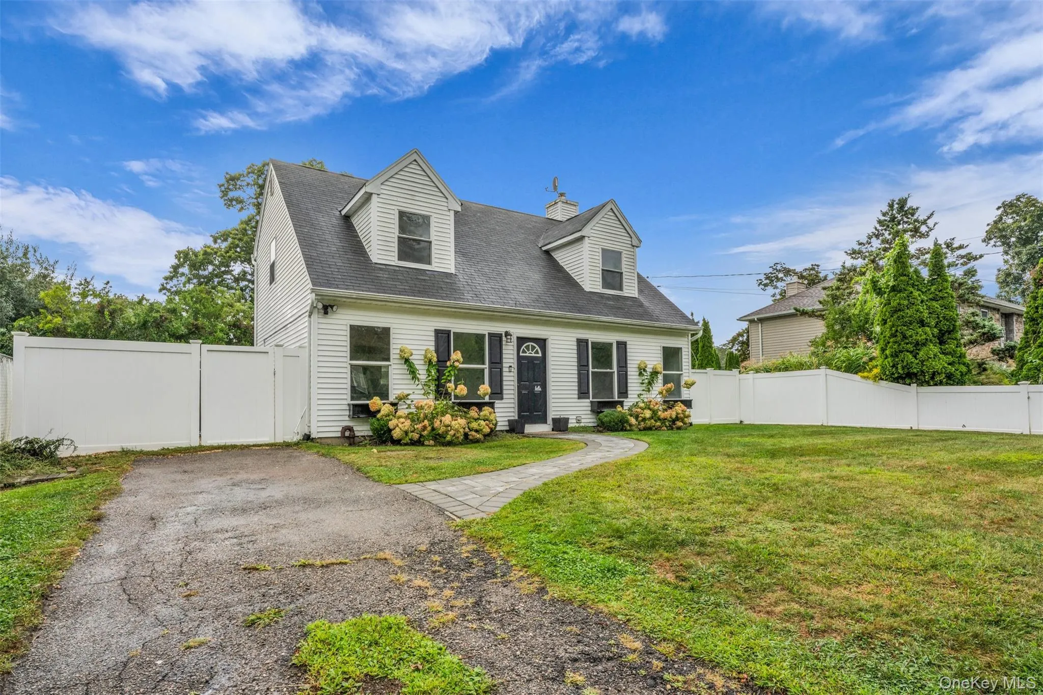 Cape cod house featuring a shingled roof and a gate Cape cod house featuring a shingled roof and a gate
