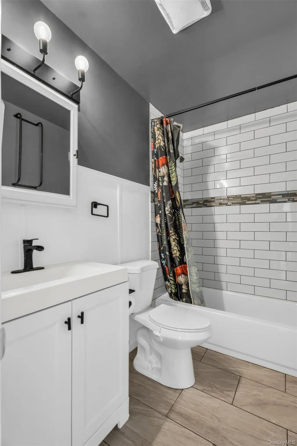 Full bathroom featuring shower / tub combo with curtain and vanity Full bathroom featuring shower / tub combo with curtain and vanity