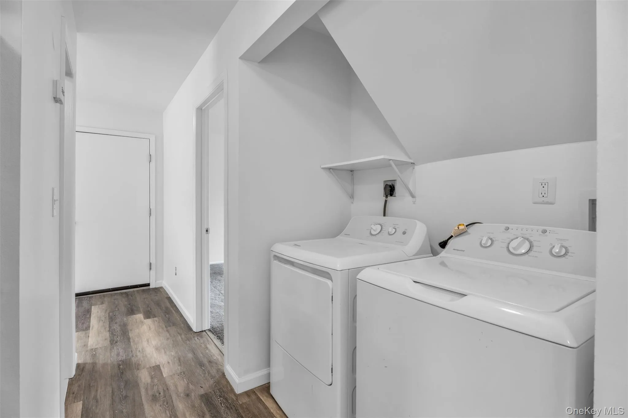 Washroom with dark wood finished floors and separate washer and dryer Washroom with dark wood finished floors and separate washer and dryer