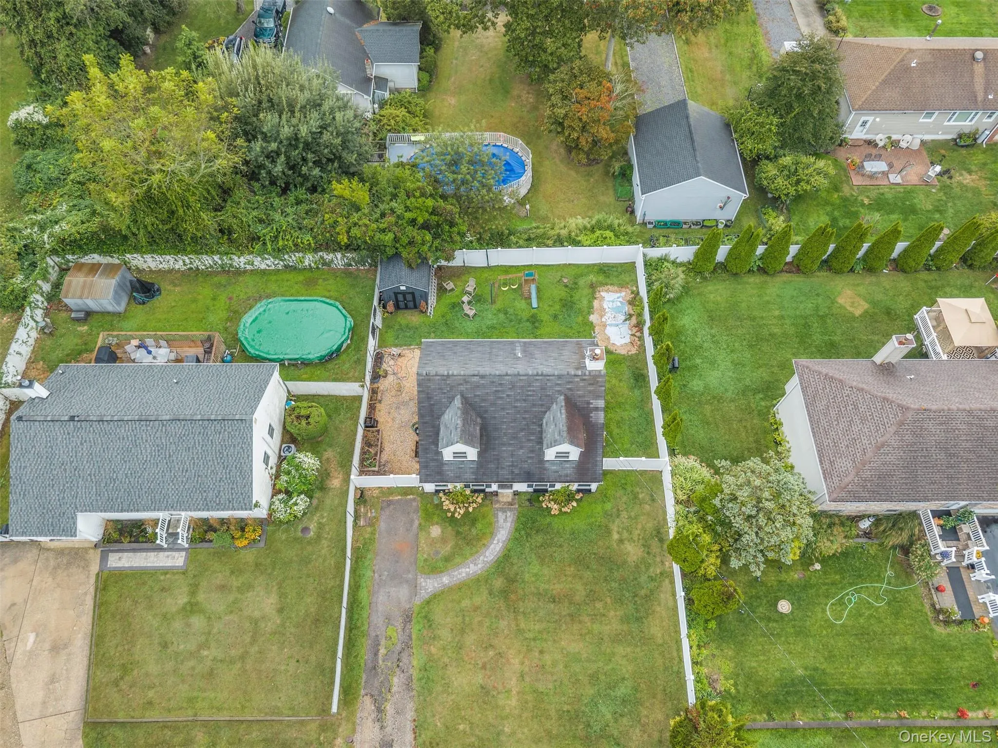 Aerial view of property and surrounding area with a pool area Aerial view of property and surrounding area with a pool area