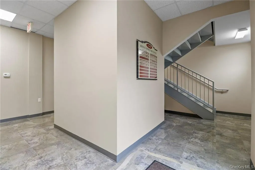 Foyer by the main entrance of the building where the elevator and the staircase to the upstairs levels... Foyer by the main entrance of the building where the elevator and the staircase to the upstairs levels...