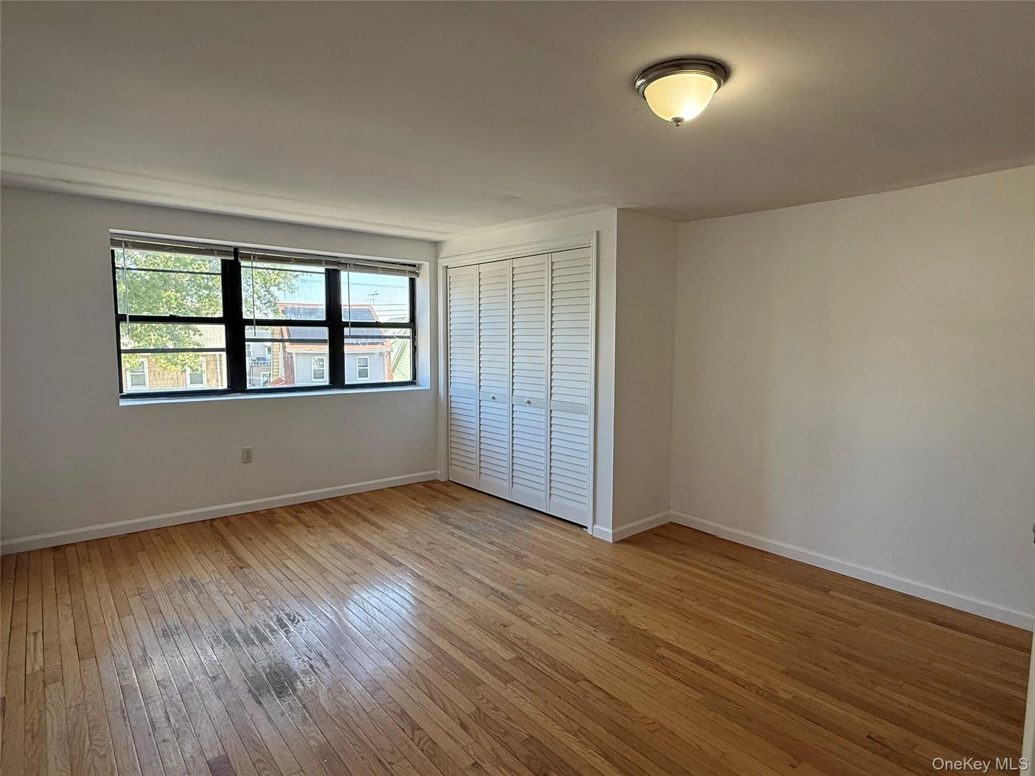 Unfurnished bedroom featuring light wood-style floors and a closet Unfurnished bedroom featuring light wood-style floors and a closet