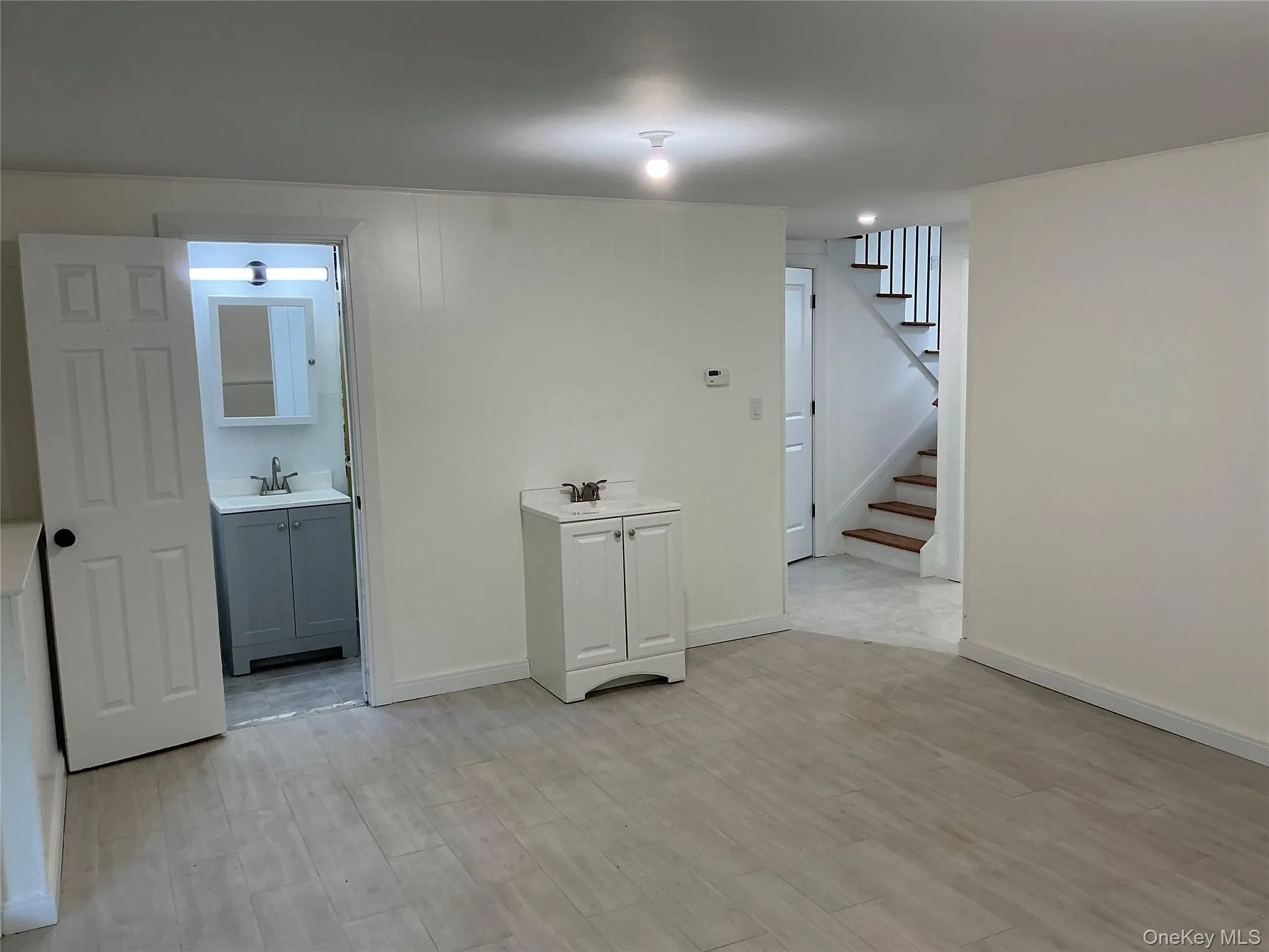 Finished below grade area with light wood finished floors and stairs Finished below grade area with light wood finished floors and stairs