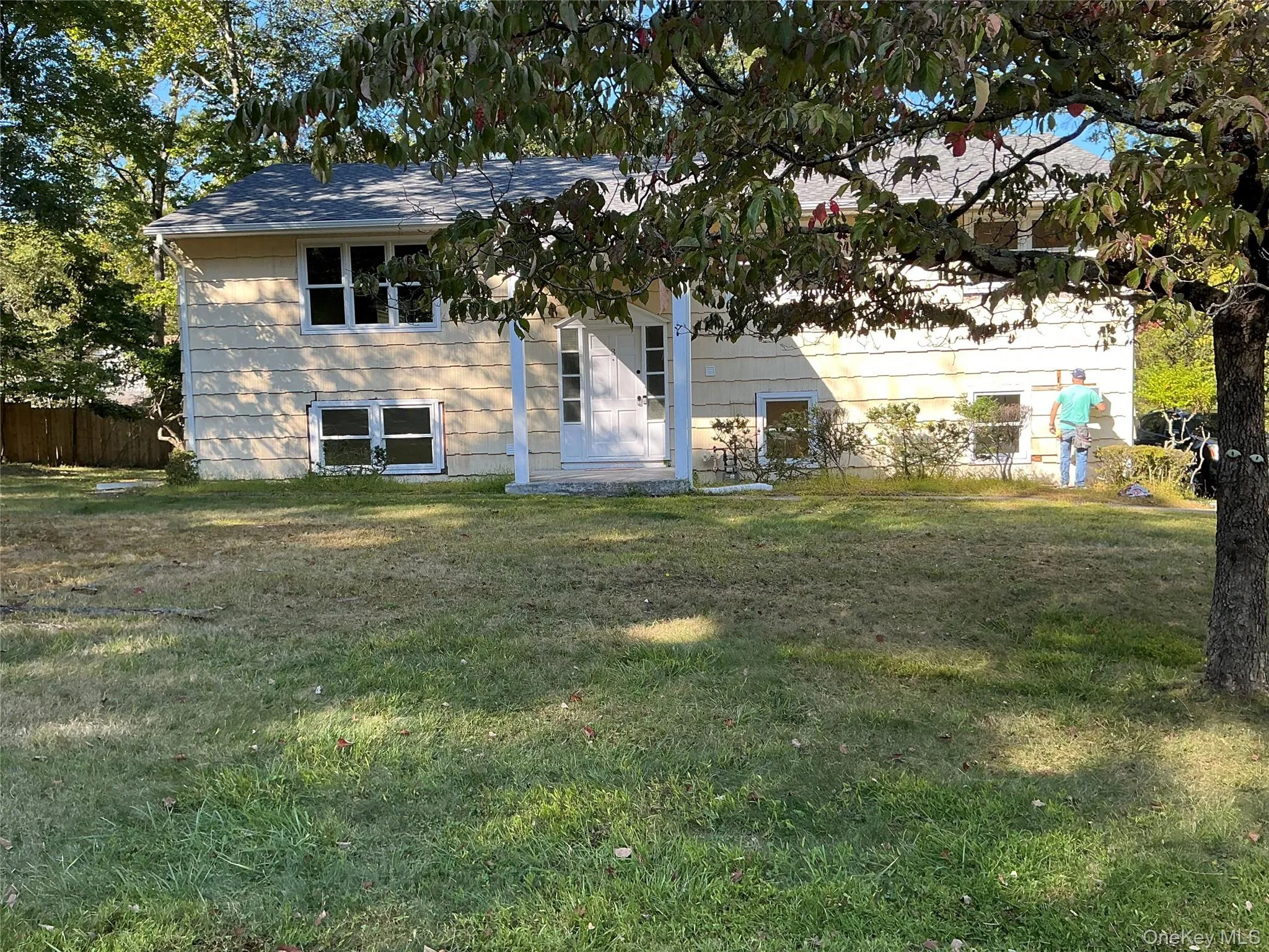Split foyer home featuring a front lawn Split foyer home featuring a front lawn