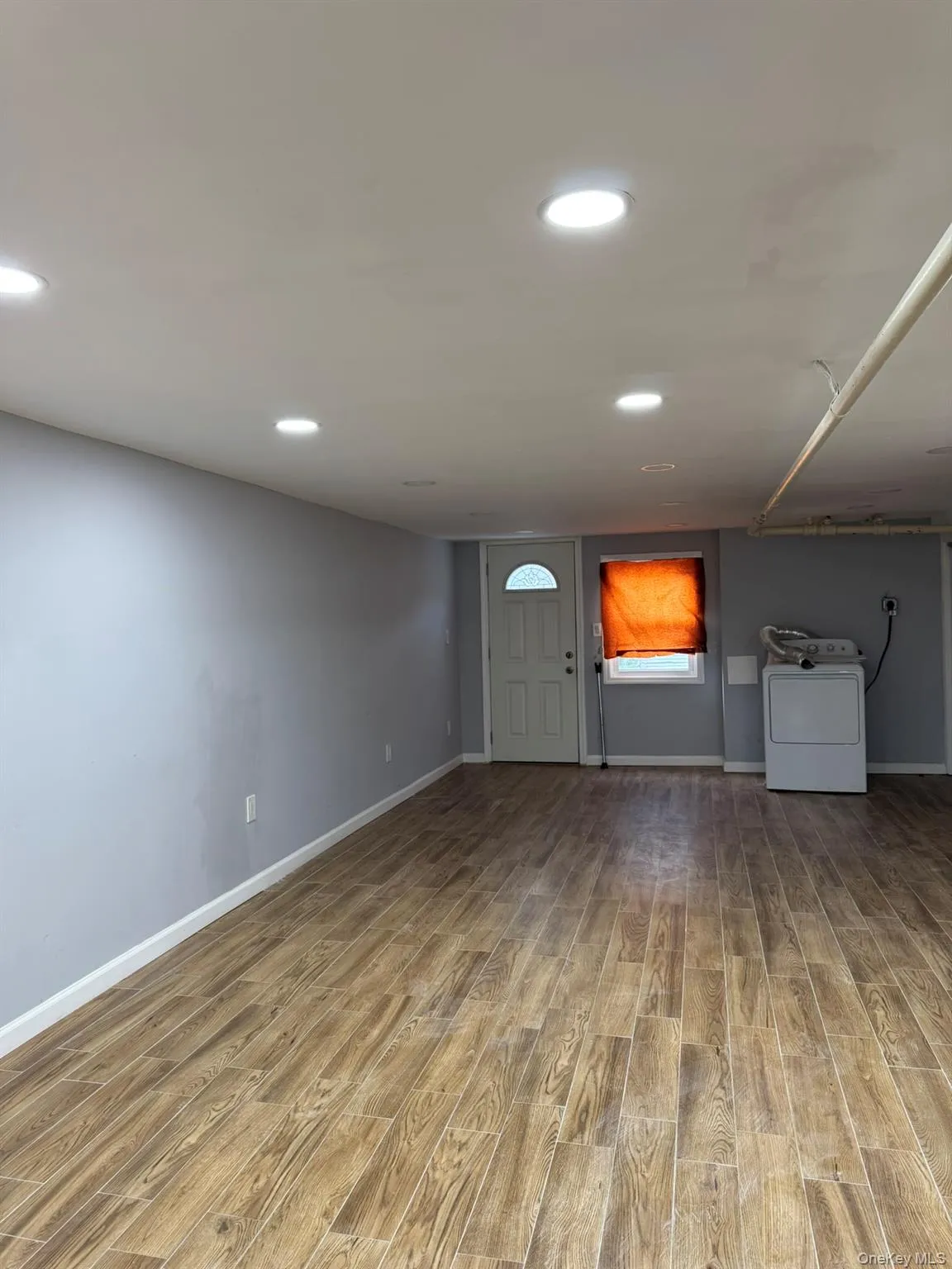 Foyer featuring light wood-style flooring, washer / clothes dryer, and recessed lighting Foyer featuring light wood-style flooring, washer / clothes dryer, and recessed lighting