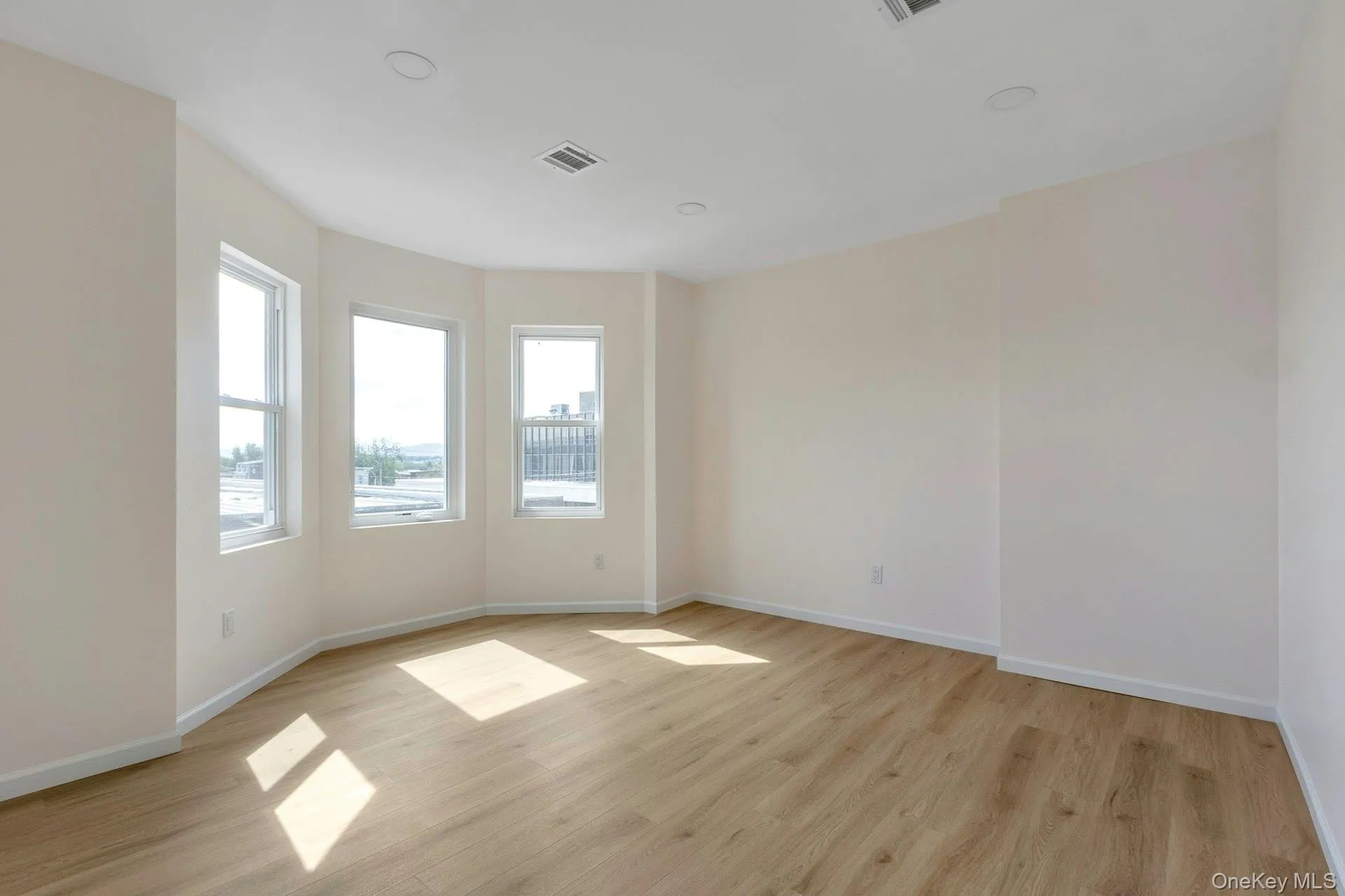 Empty room with light wood-type flooring and recessed lighting Empty room with light wood-type flooring and recessed lighting