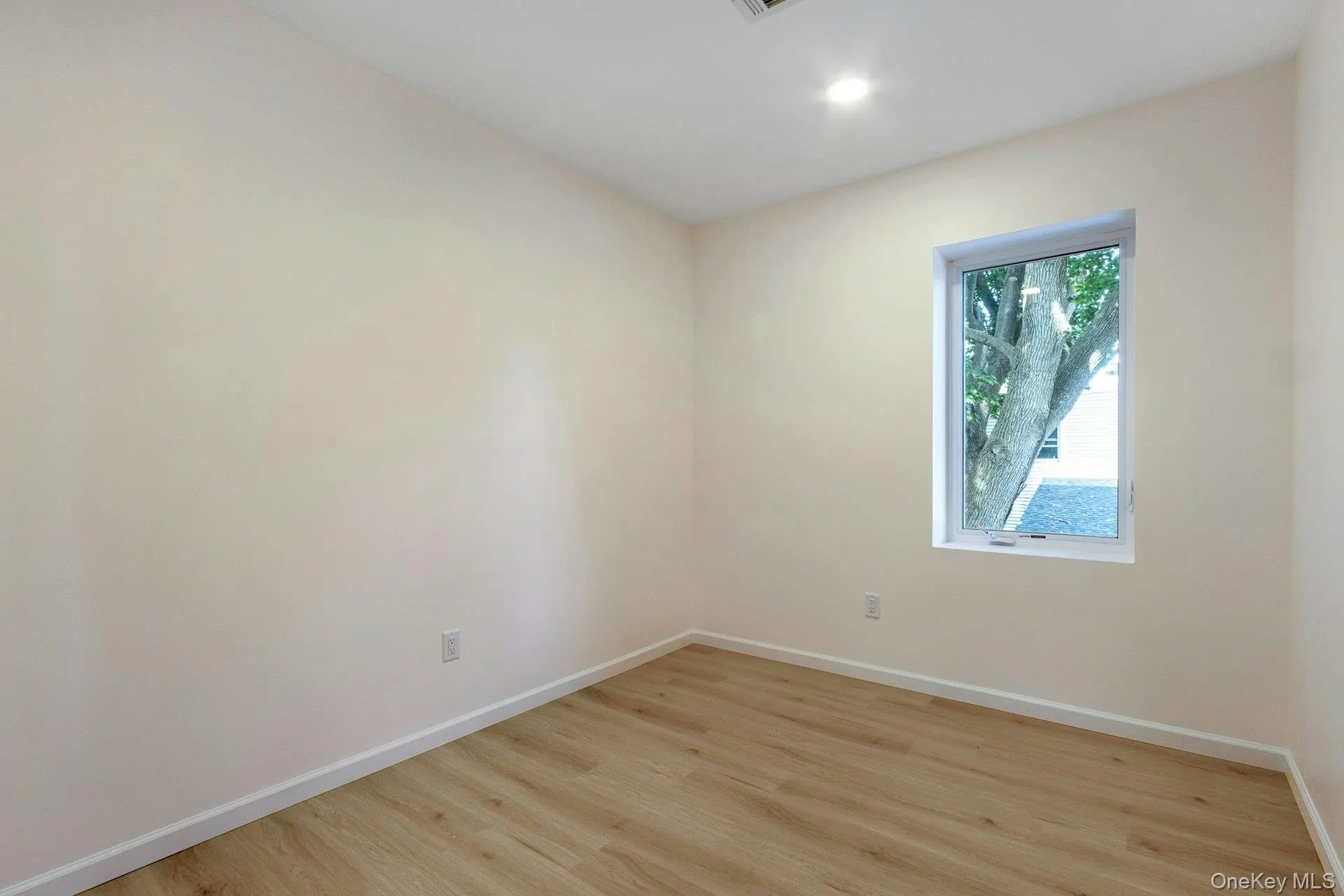 Spare room with light wood-type flooring and recessed lighting Spare room with light wood-type flooring and recessed lighting