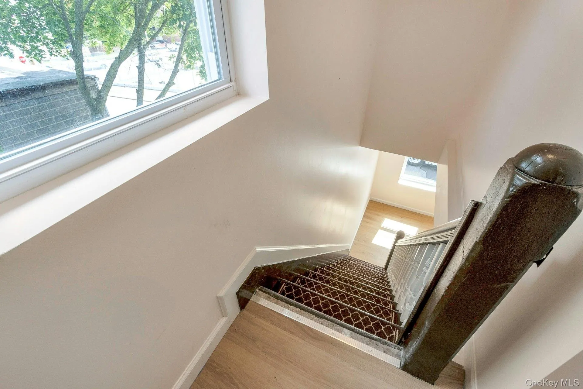 Stairs featuring wood finished floors and baseboards Stairs featuring wood finished floors and baseboards