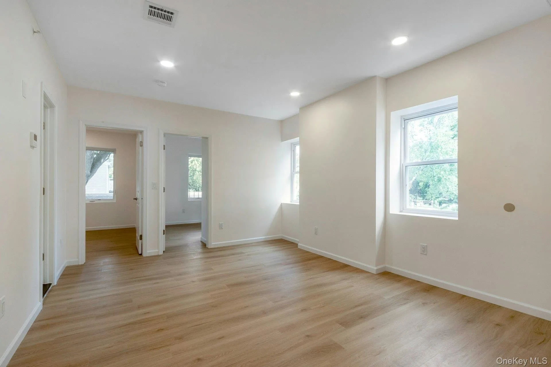 Unfurnished room with light wood-style floors and recessed lighting Unfurnished room with light wood-style floors and recessed lighting