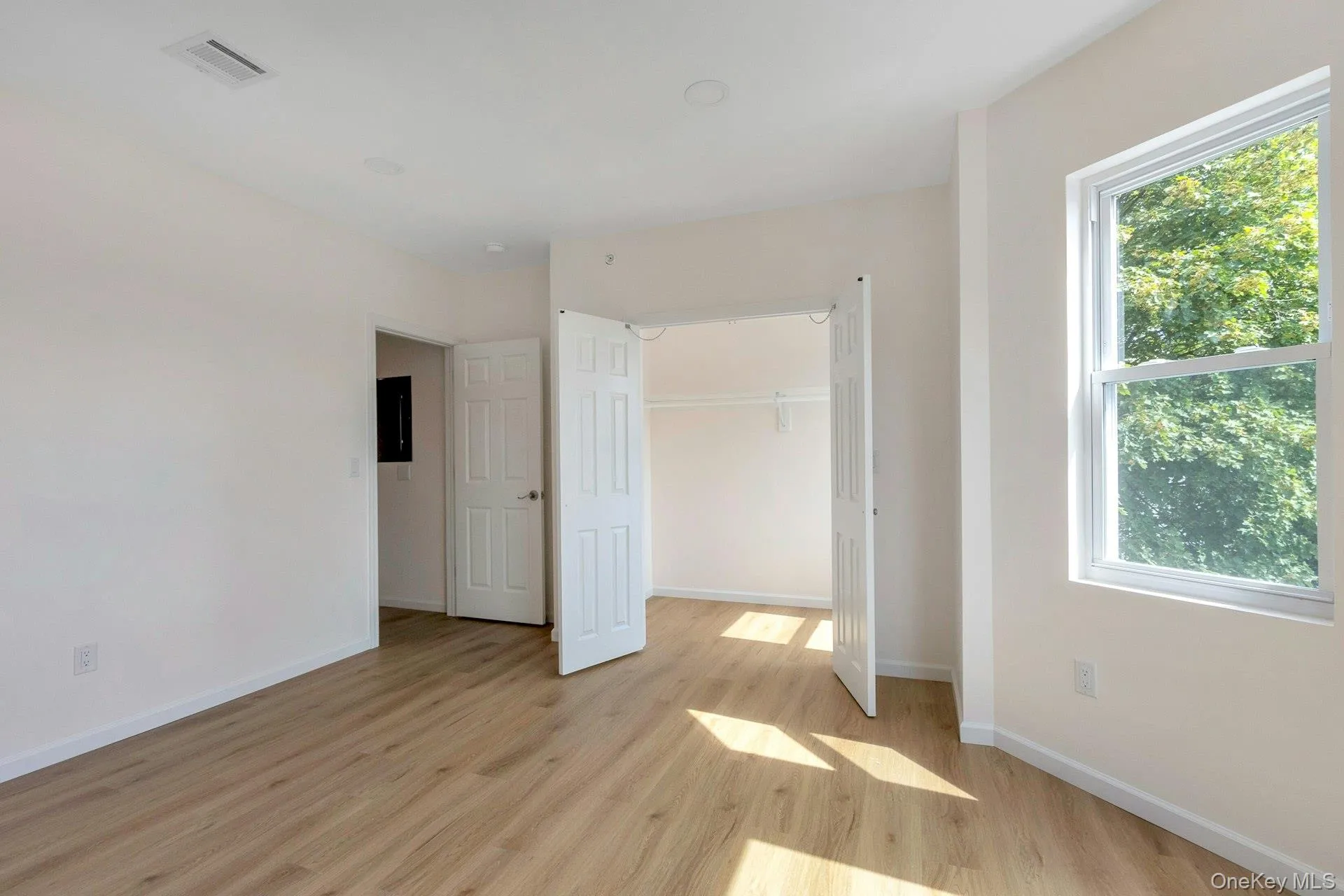 Unfurnished bedroom with light wood-style flooring and a closet Unfurnished bedroom with light wood-style flooring and a closet