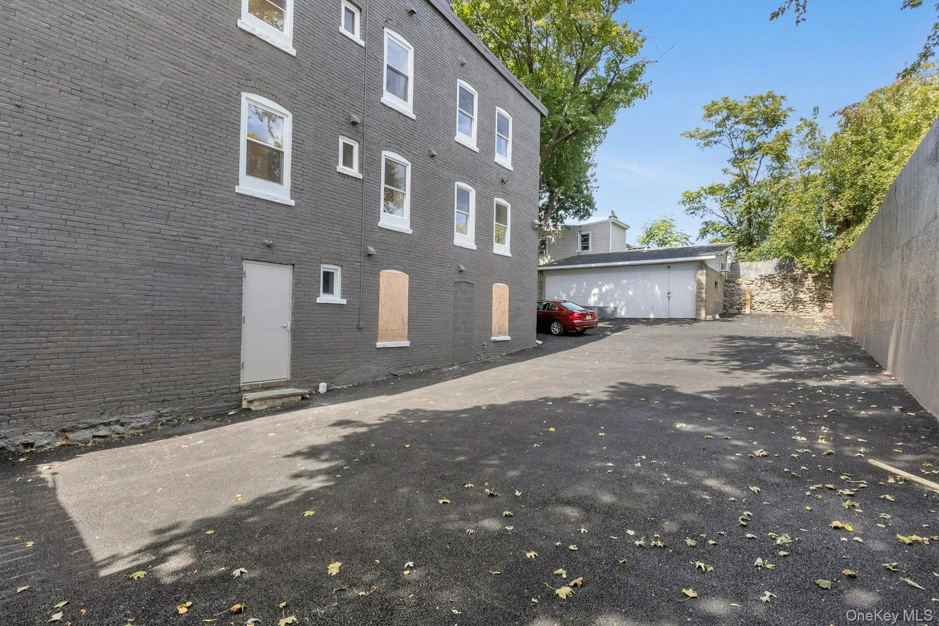 View of side of property featuring brick siding and an outbuilding View of side of property featuring brick siding and an outbuilding