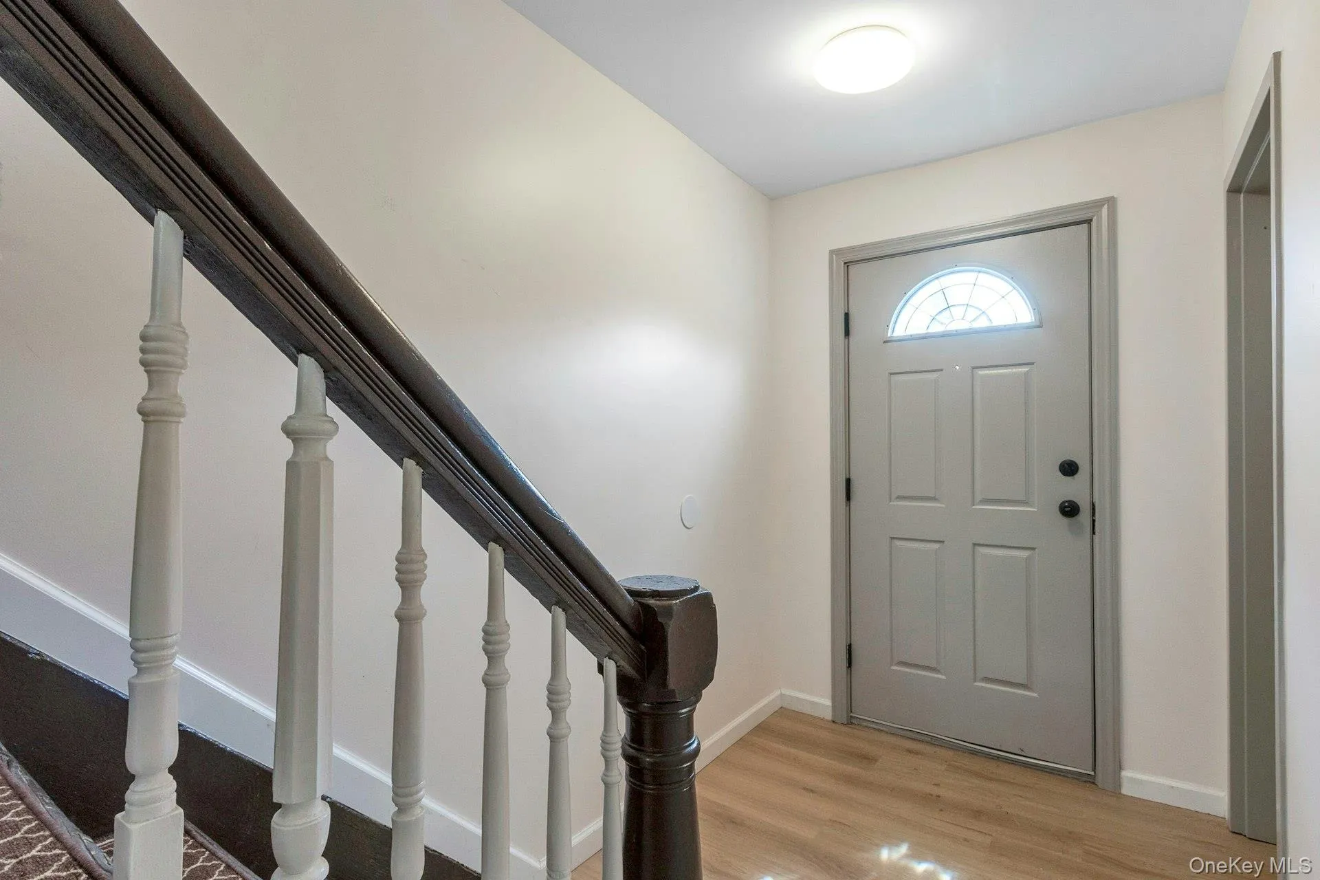 Entryway with stairs and light wood-type flooring Entryway with stairs and light wood-type flooring
