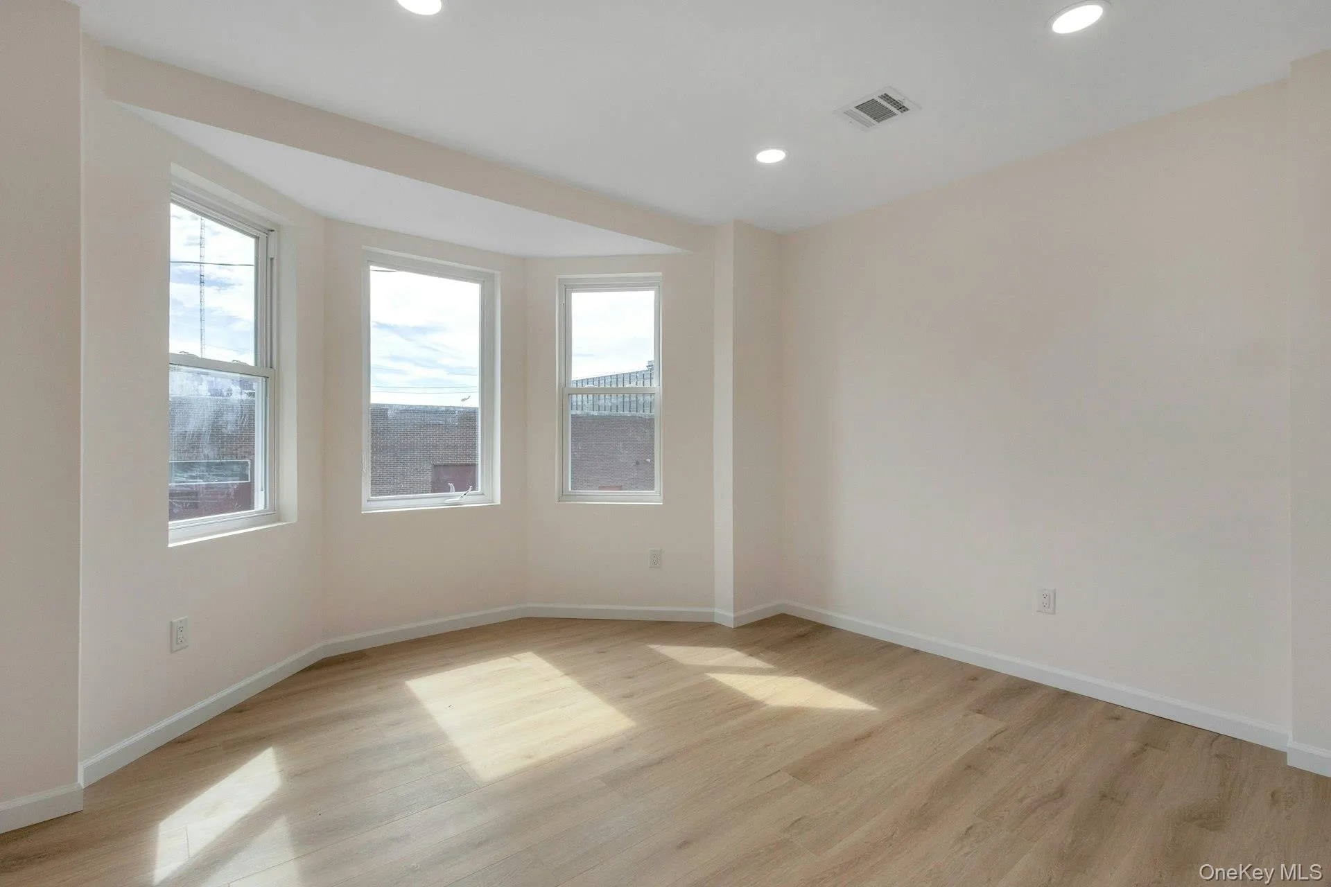 Unfurnished room with light wood-style floors and recessed lighting Unfurnished room with light wood-style floors and recessed lighting