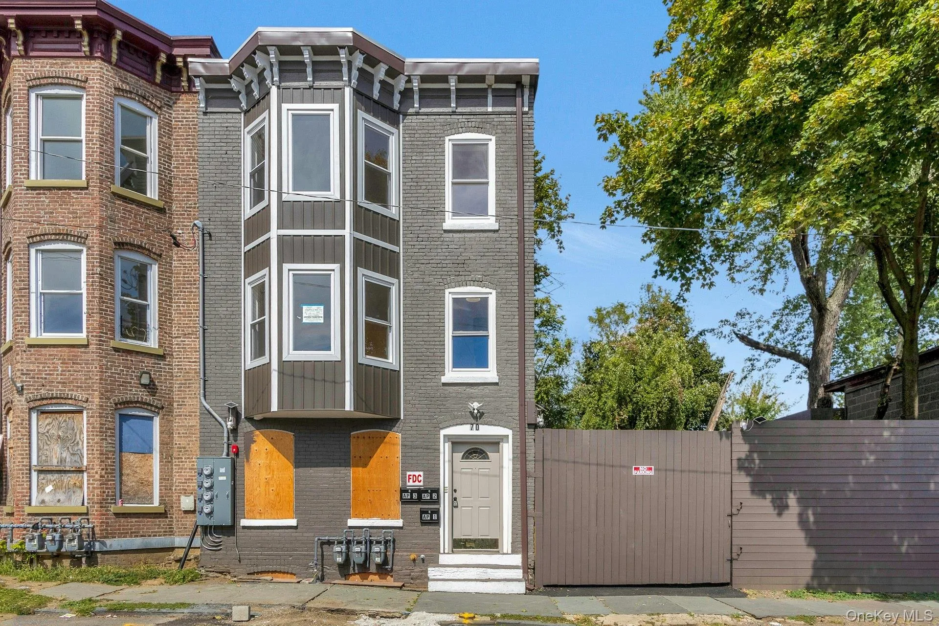 Italianate house with a gate and brick siding Italianate house with a gate and brick siding