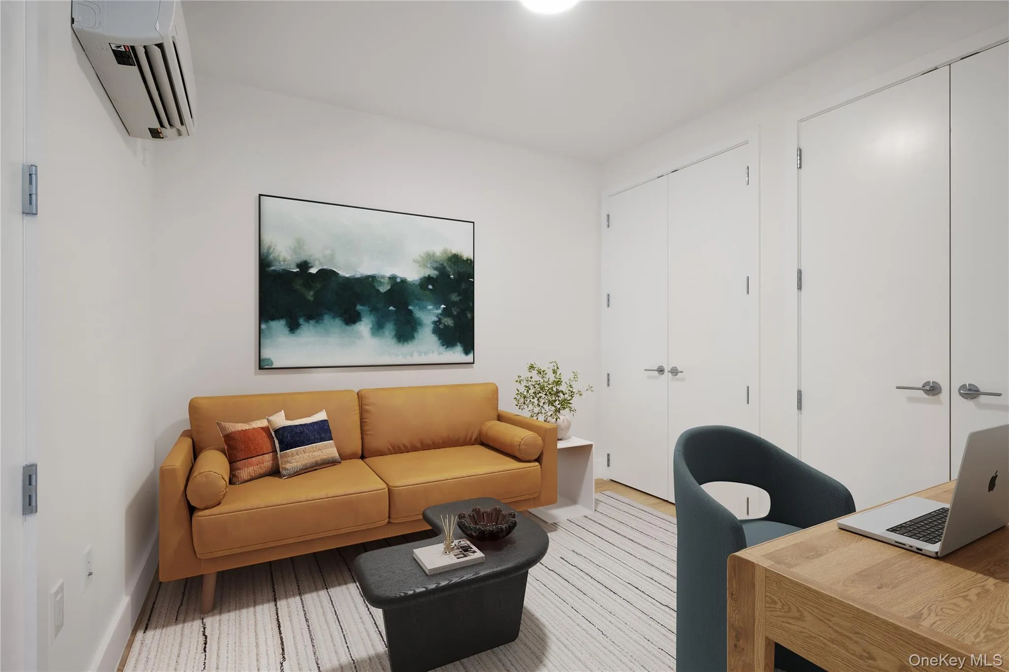 Living area featuring an office area, a wall mounted AC, and wood finished floors Living area featuring an office area, a wall mounted AC, and wood finished floors