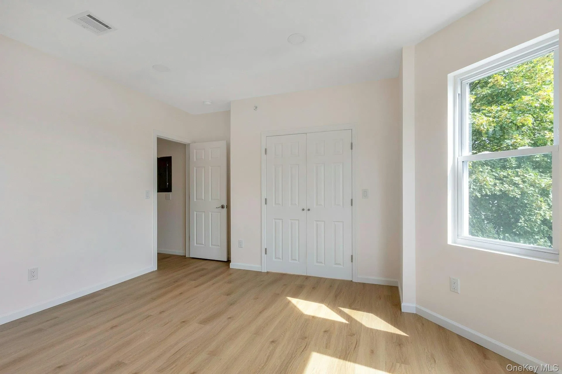 Unfurnished bedroom with light wood-type flooring and a closet Unfurnished bedroom with light wood-type flooring and a closet