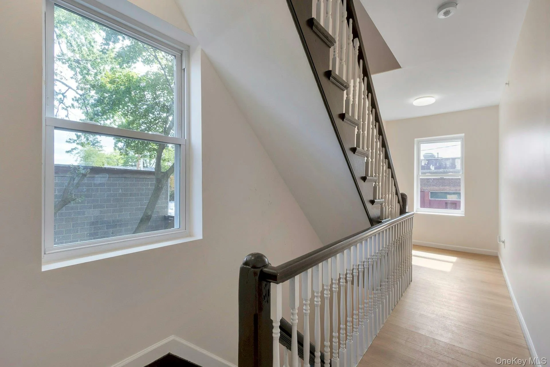 Staircase featuring baseboards and wood finished floors Staircase featuring baseboards and wood finished floors